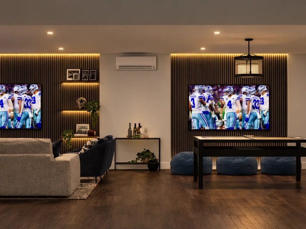 Basement lounge with sectional sofa and wall-mounted TVs