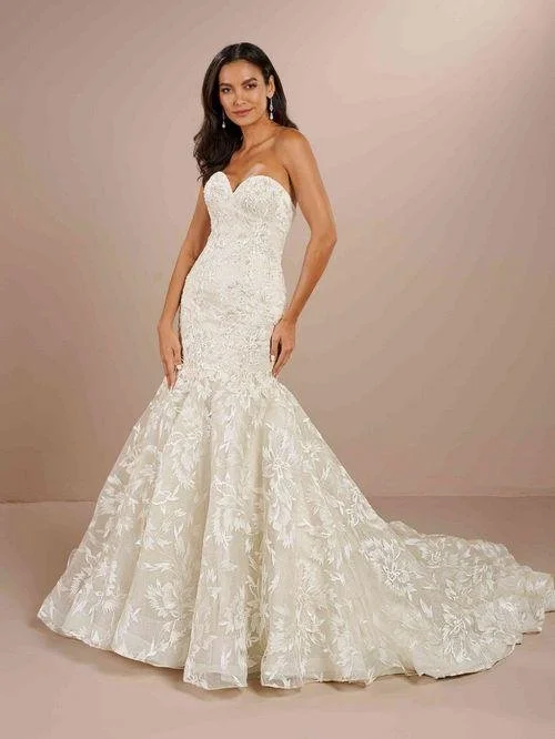 Woman wearing a white strapless lace wedding gown with floral patterns, fitted bodice, and a long train against a neutral background.