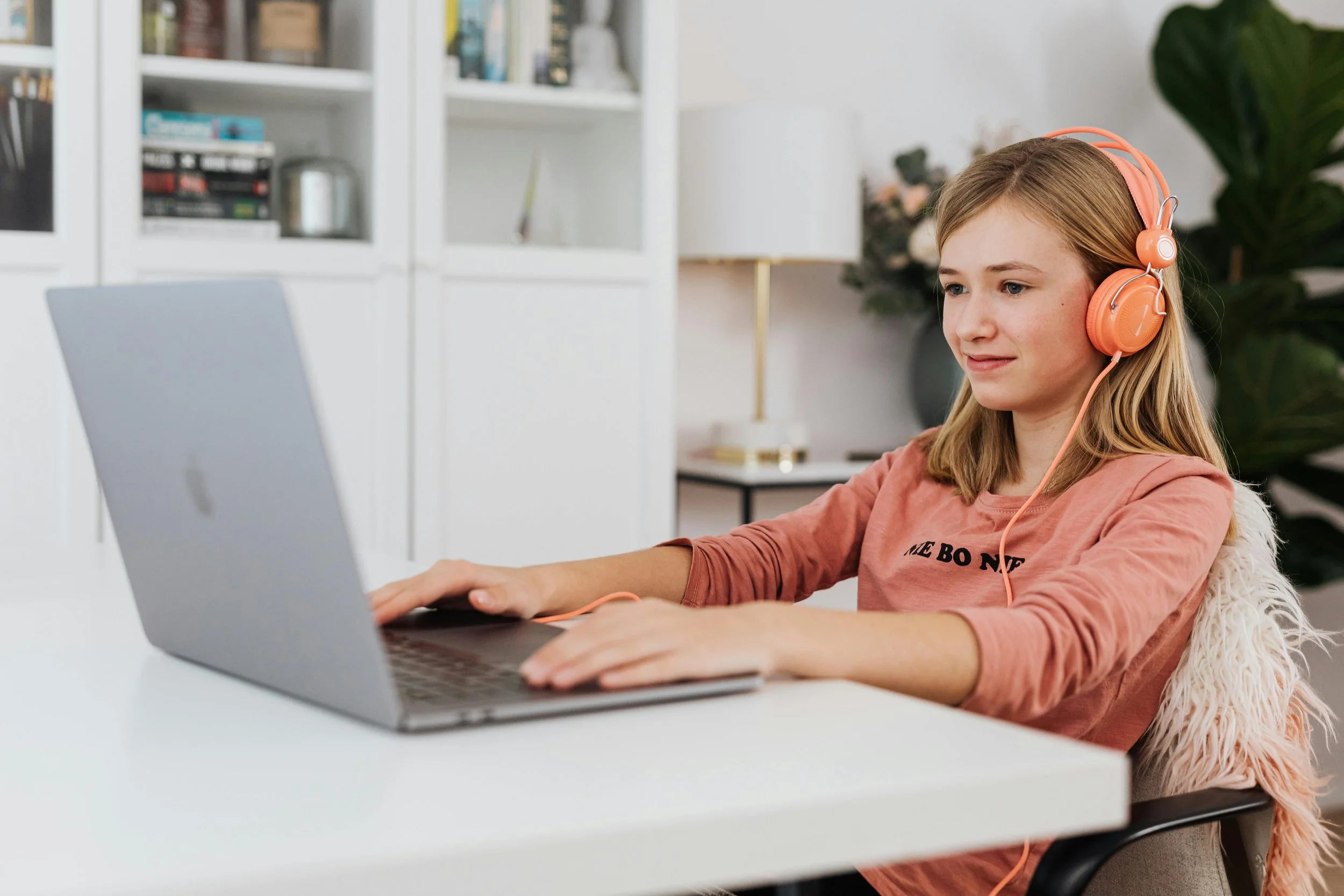 A student sits on their laptop