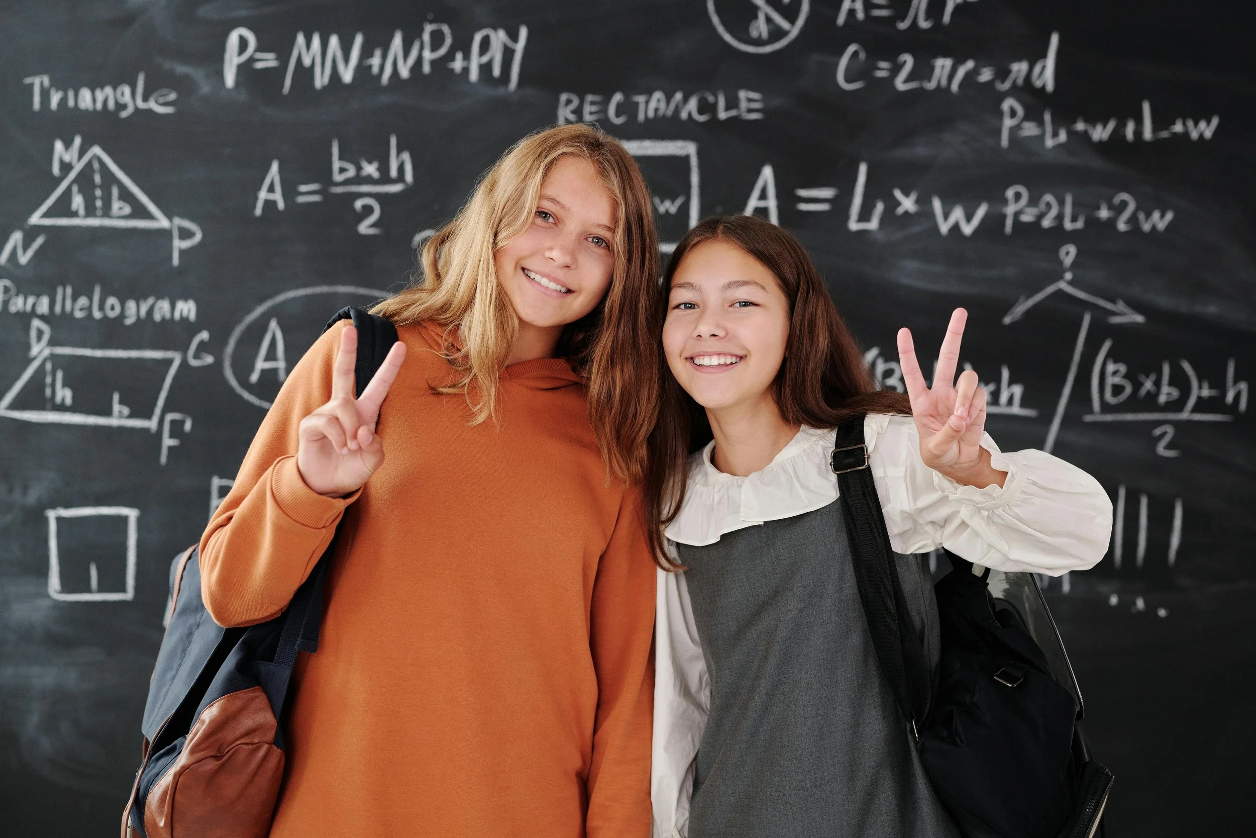 Two students smiling at the camera