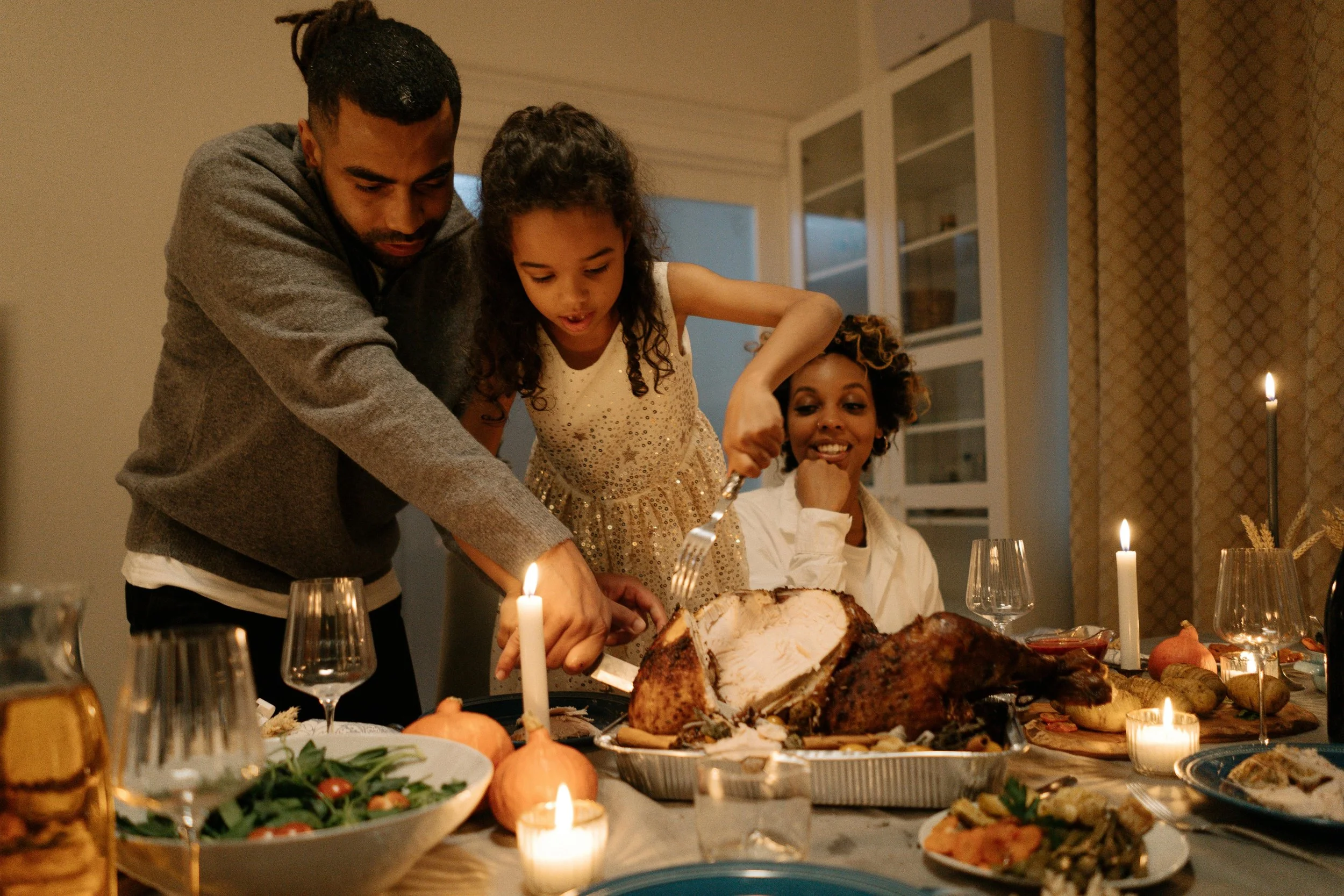 A family cutting a thanksgiving turkey