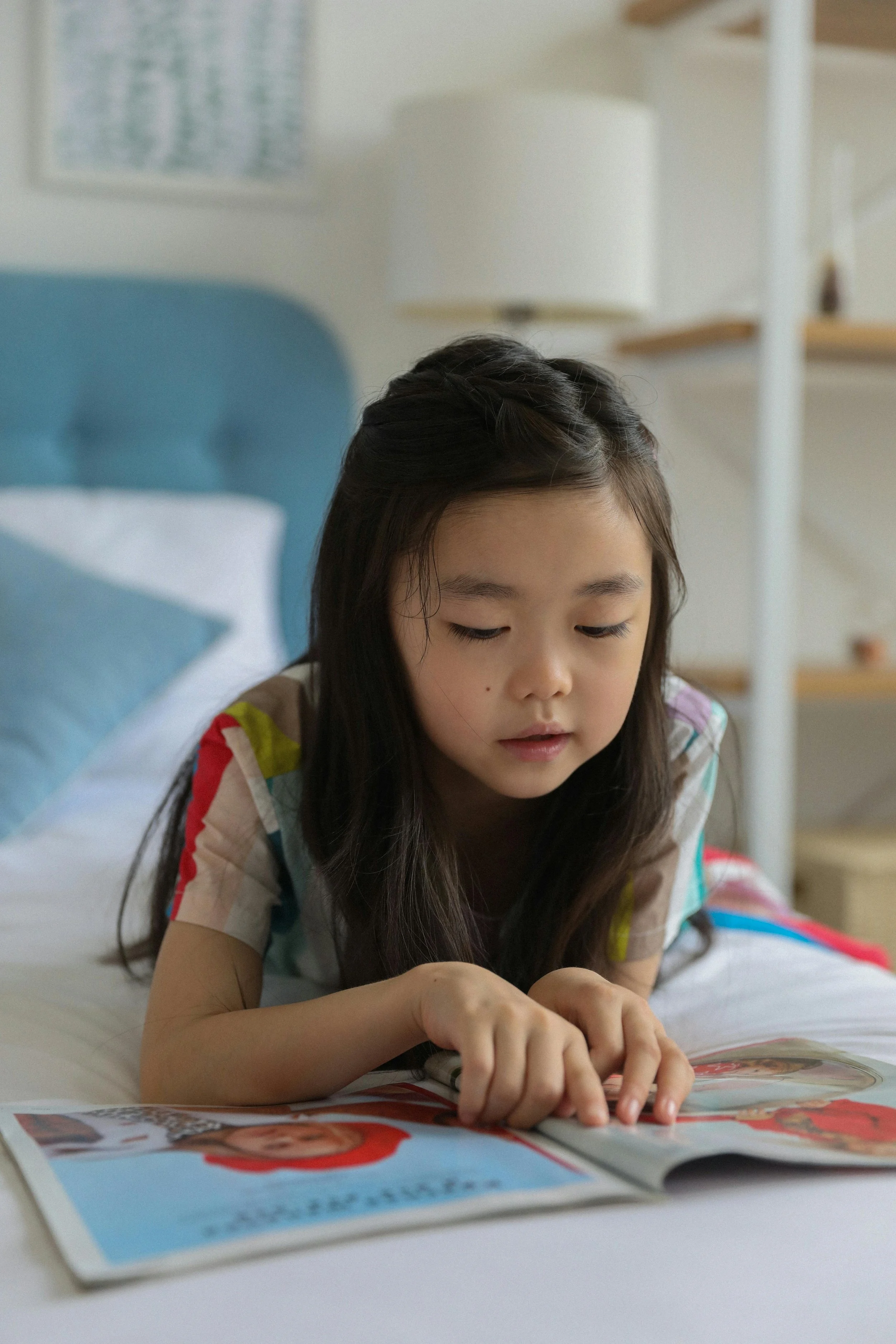 A child reading in their bedroom