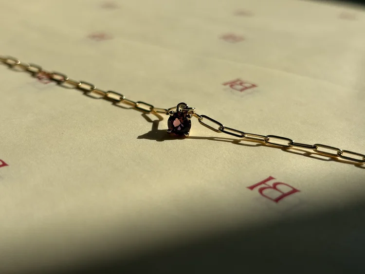 A pink tourmaline pendant on a fine gold chain