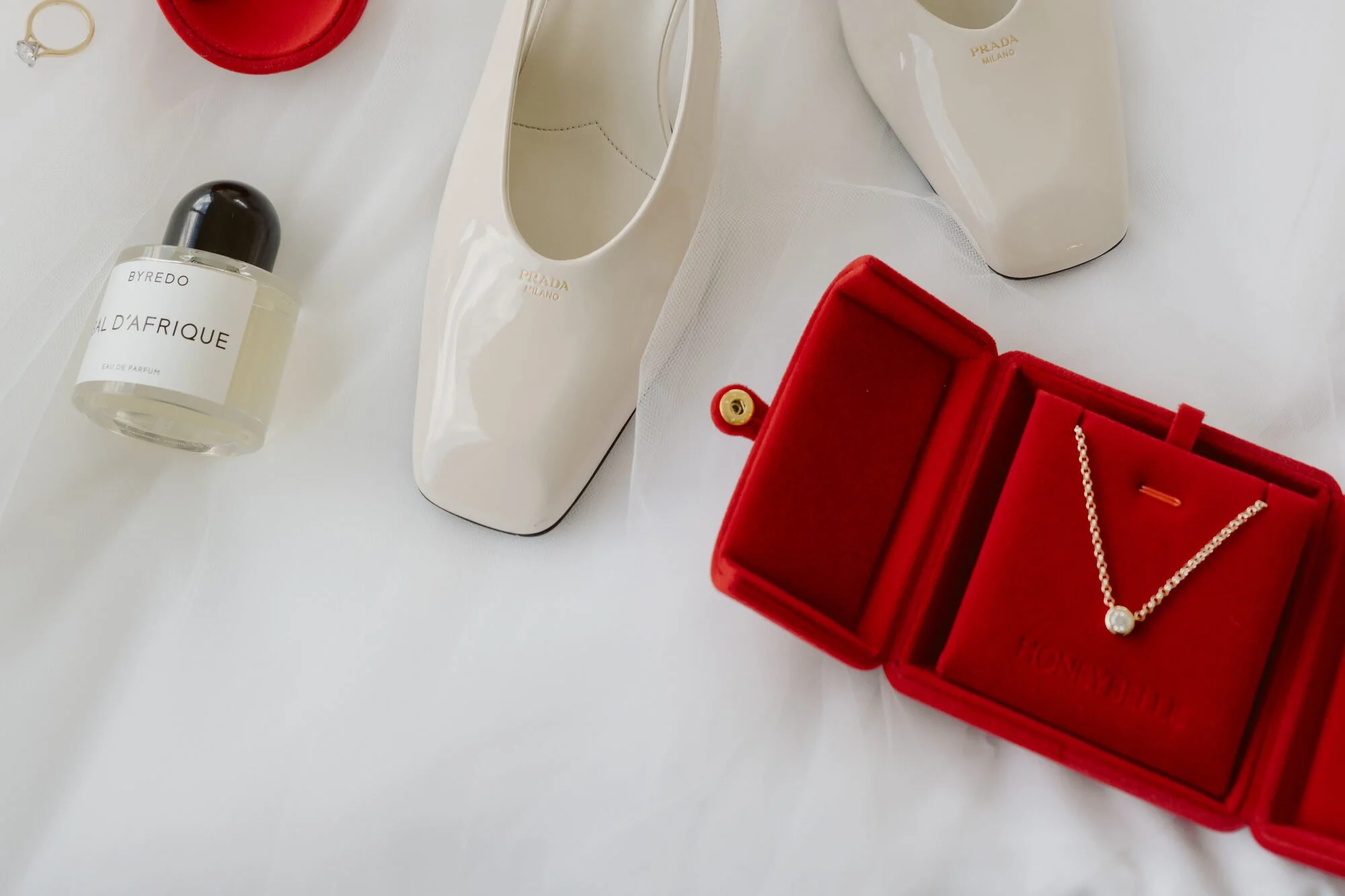 The HoneyBelle Coco Necklace with a natural diamond in its red HoneyBelle box on the wedding morning