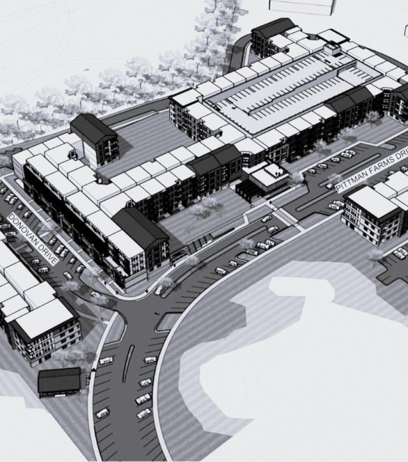 Vista aérea de un complejo de apartamentos y un estacionamiento, con calles y árboles alrededor