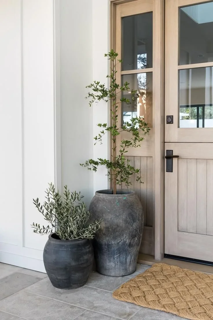Design inspiration for Landrum Mill in Landrum, SC, featuring a natural wood entry door, greenery and understated Southern style.