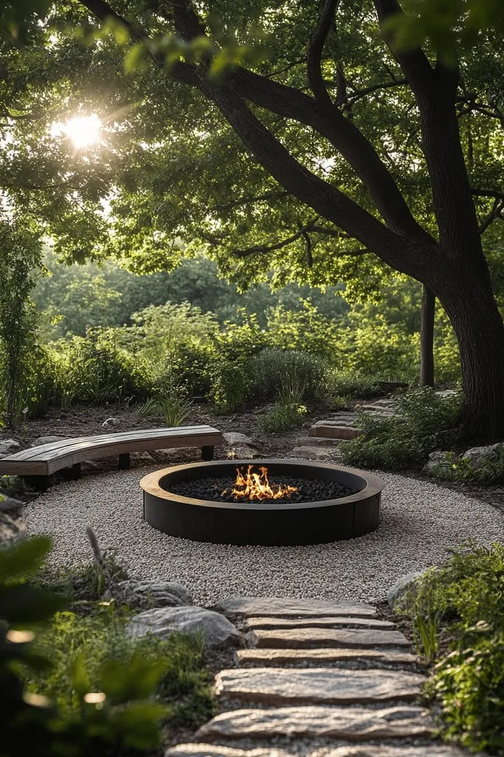 Outdoor living inspiration for Landrum Mill in Landrum, SC, featuring a modern fire pit surrounded by natural landscaping and mature trees.