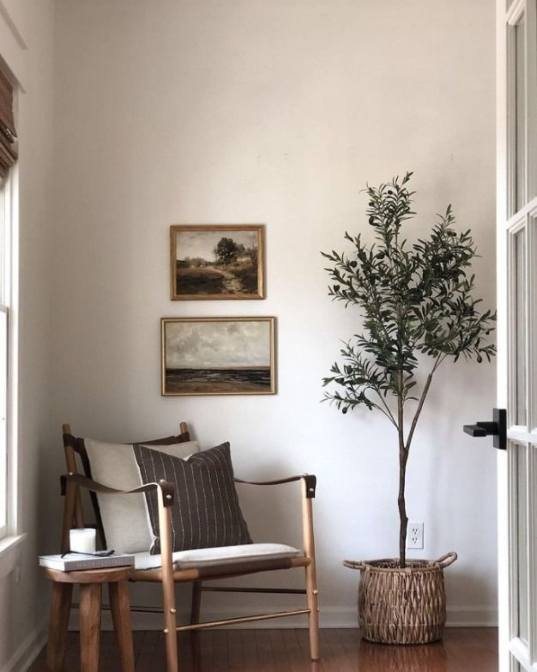 Interior design inspiration for 26 Pacific Ave in Greenville, SC, featuring warm wood tones, neutral furnishings, vintage artwork and natural greenery.