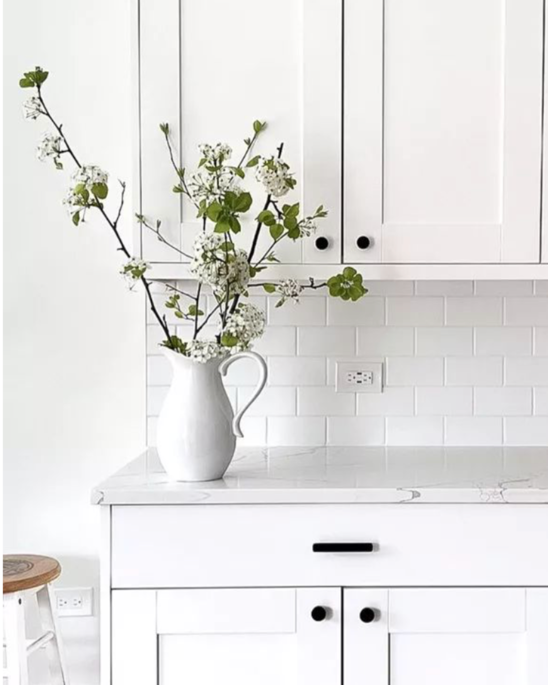 Kitchen design inspiration for 26 Pacific Ave in Greenville, SC, featuring white cabinetry, black hardware and a bright neutral palette.