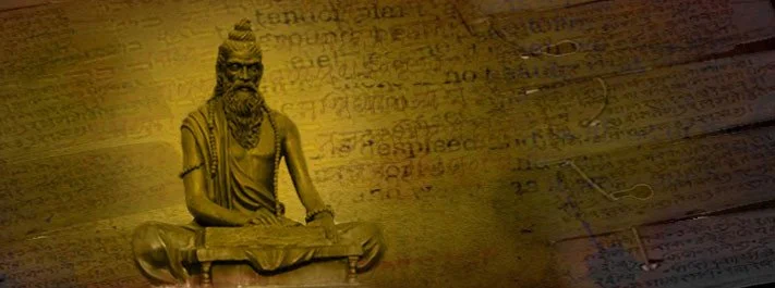 Statue of the yoga sage Patanjali on a background on sanskrit writing