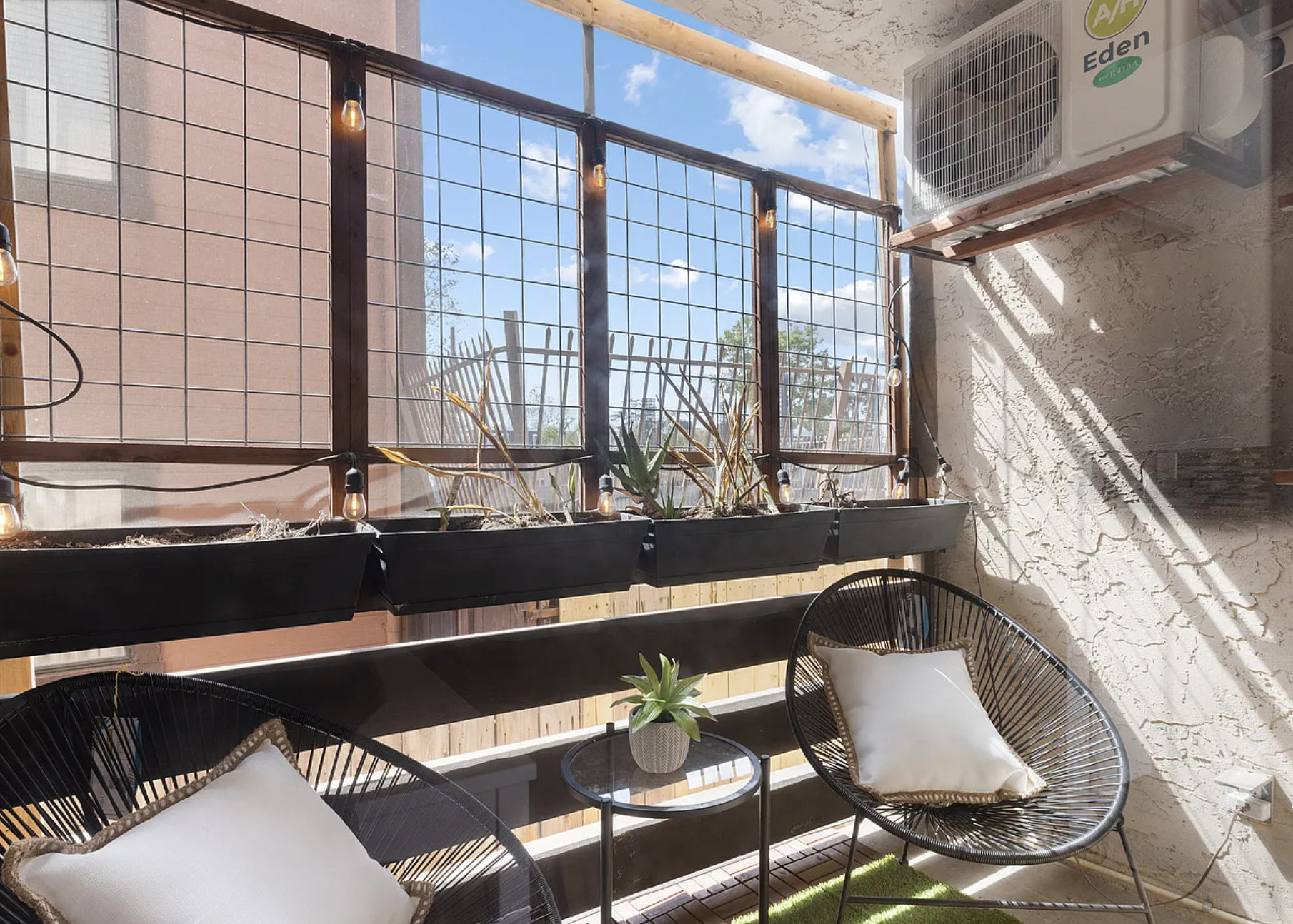 Cozy balcony with chairs and plants in planters