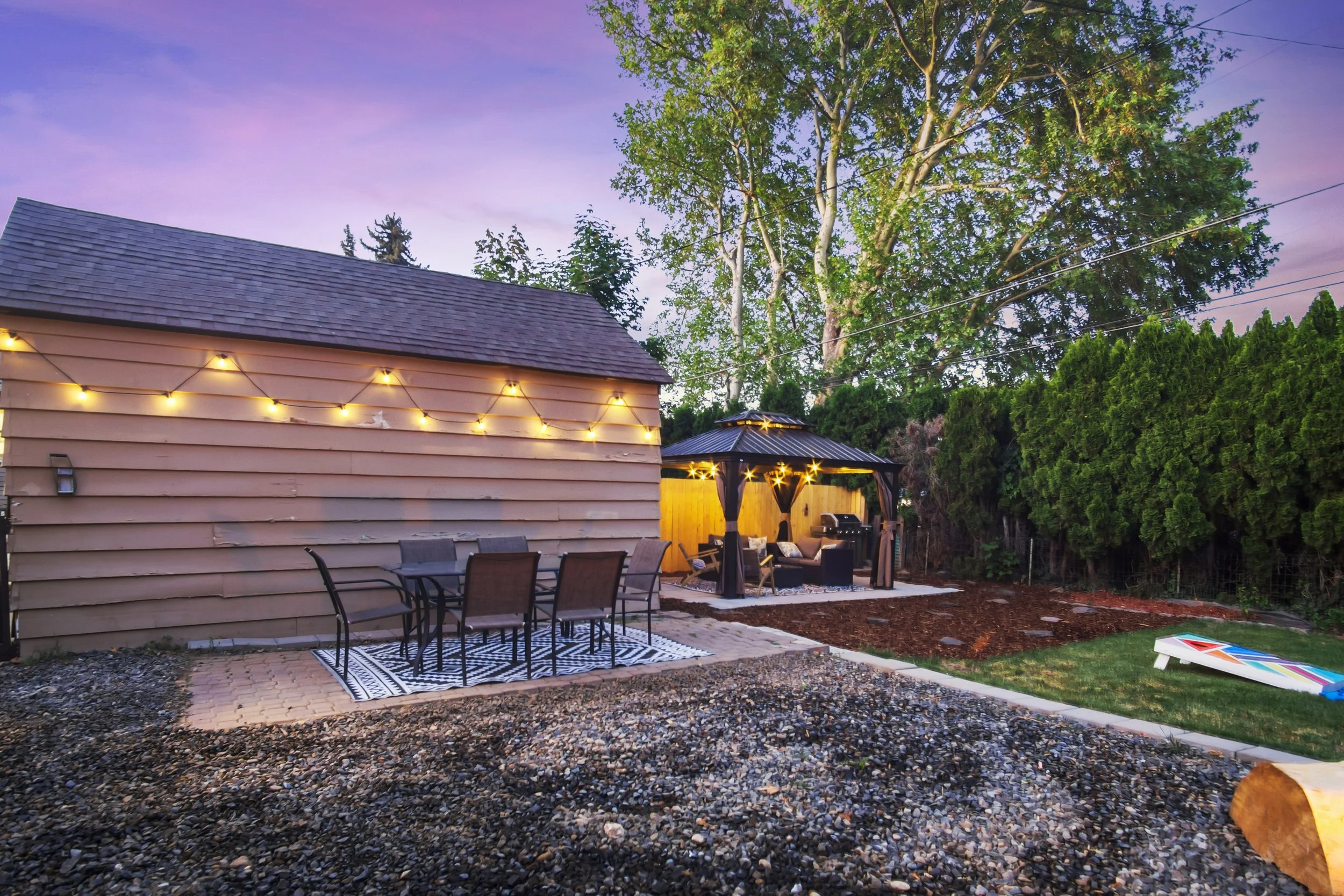 Seating for six people at the dining area outside with lights to eat at night