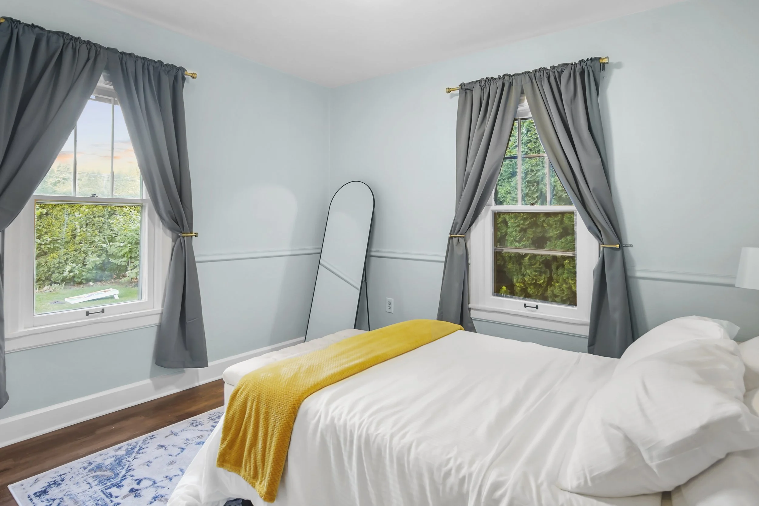 A beautifully blue room with a view of the fire pit outside