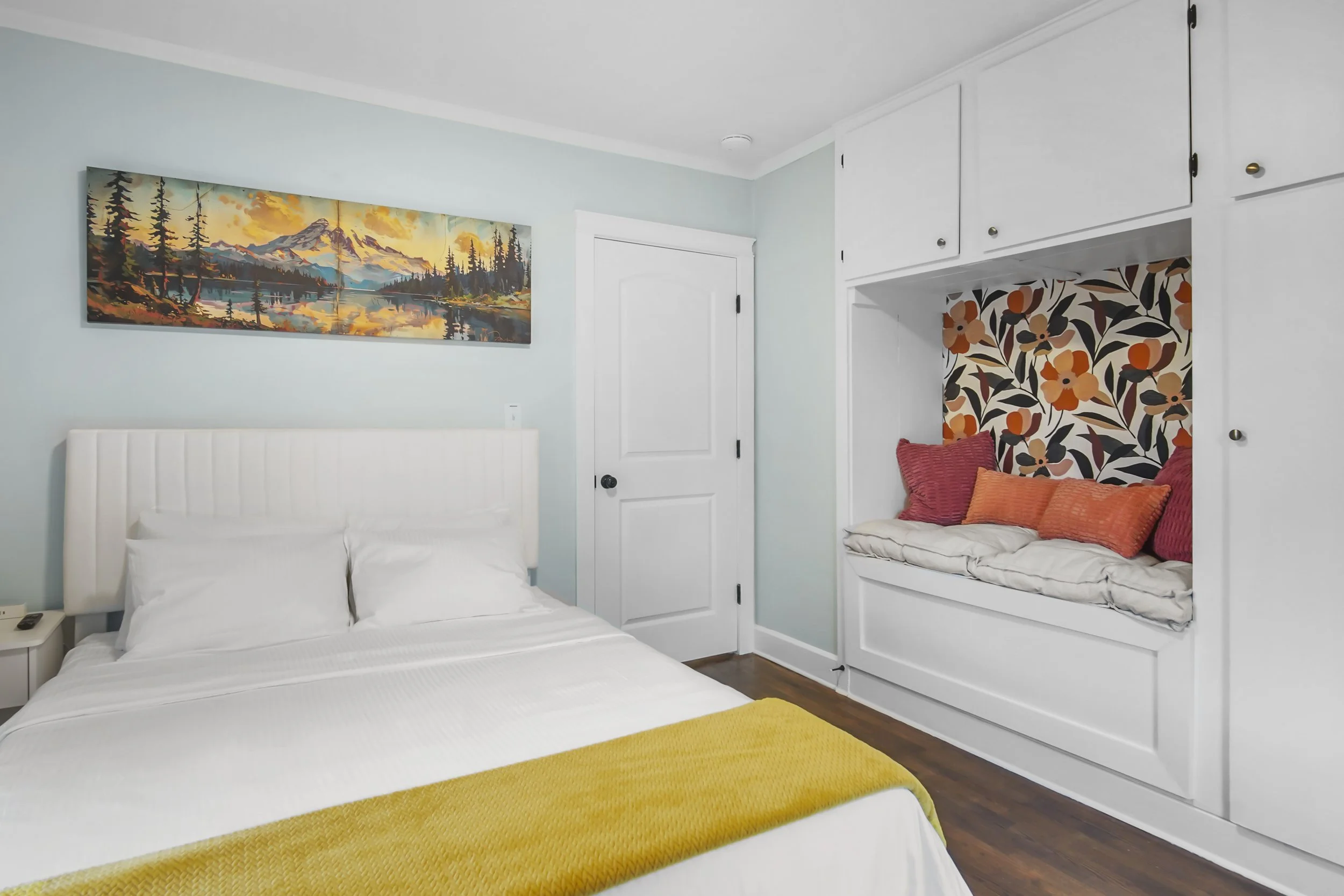Bright energetic master bedroom with floral reading nook.  Including a painting of Mount Rainier