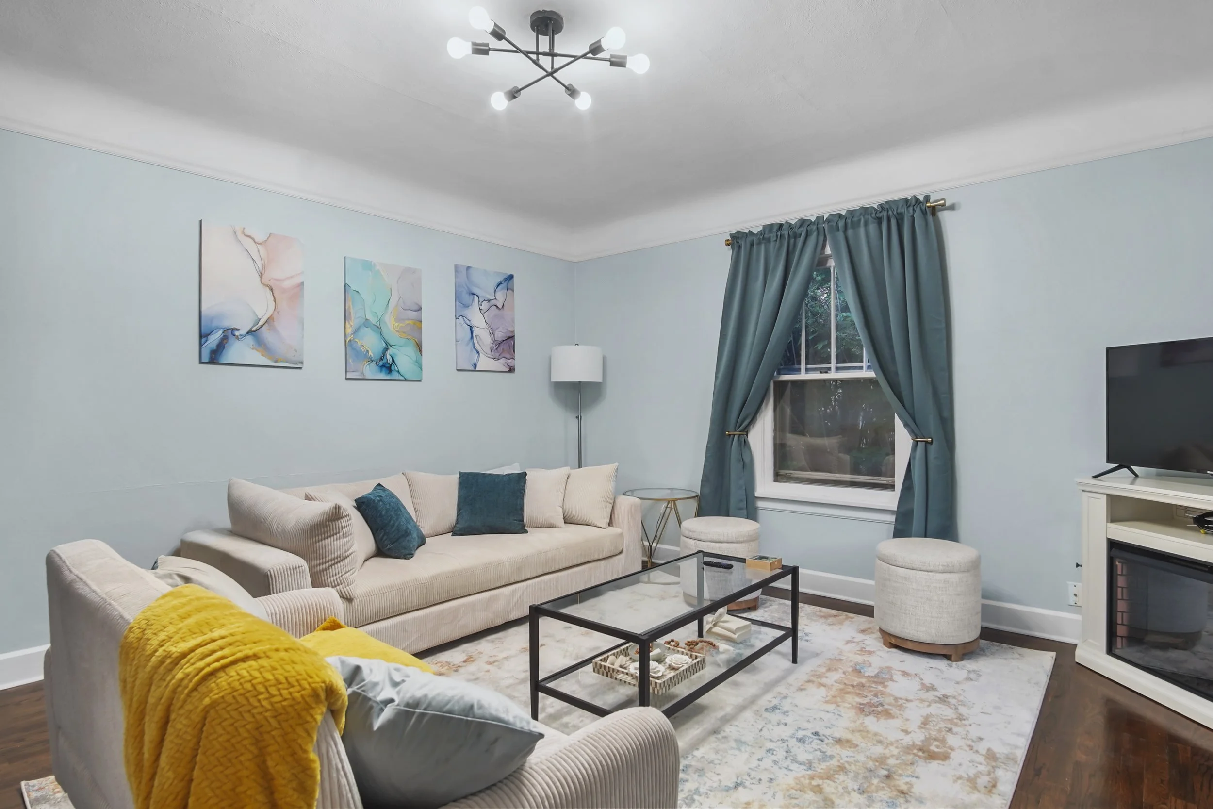 Comfy living area with warm welcoming hues and a electric fireplace