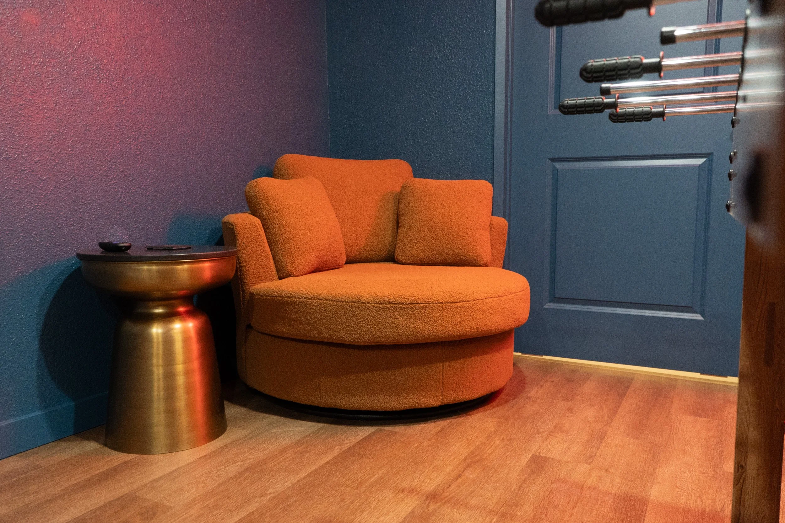 The best chair in the house is a moody rust orange chair to watch the games