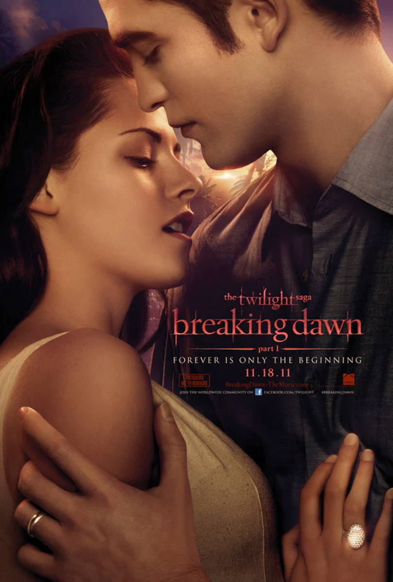 Close-up of a romantic scene from "The Twilight Saga: Breaking Dawn - Part 1," showing a man and woman with foreheads touching, eyes closed, and a sunset background.