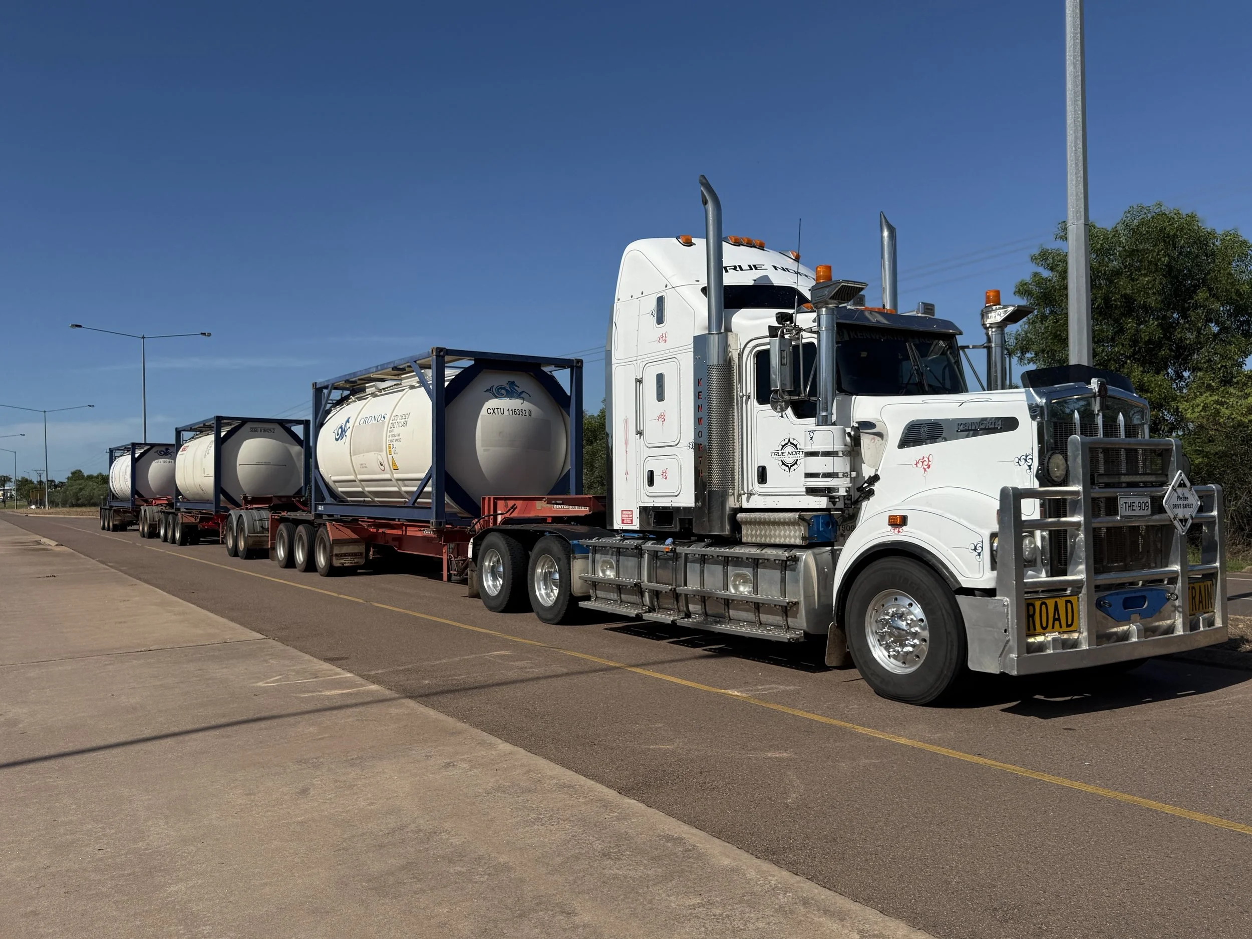 Semi-truck with multiple tank containers on a highway