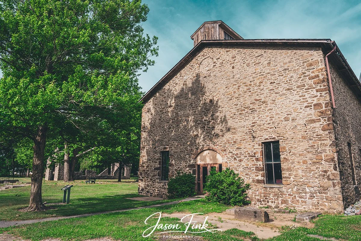 The cast house at Lock Ridge Park stands like a stone-built time capsule, its arched entranceway opening onto one of the Lehigh Valleys most enduring industrial landmarks. Once part of the Lock Ridge Iron Works, an operation that thrived in the late 