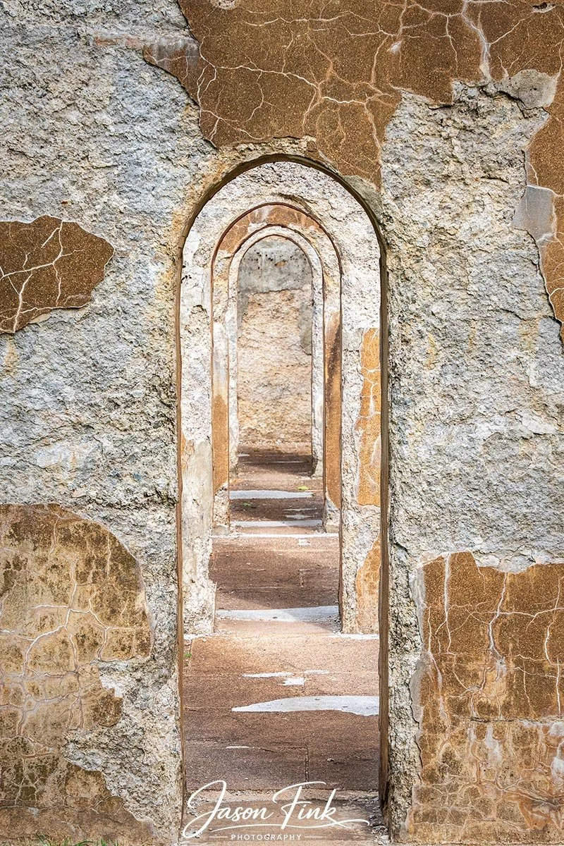 These embedded archways at Lock Ridge Park create a striking sense of rhythm and depth, each opening revealing the next in a perfectly aligned sequence. The weathered stonework textured with decades of exposure and subtle shifts in color adds a tacti