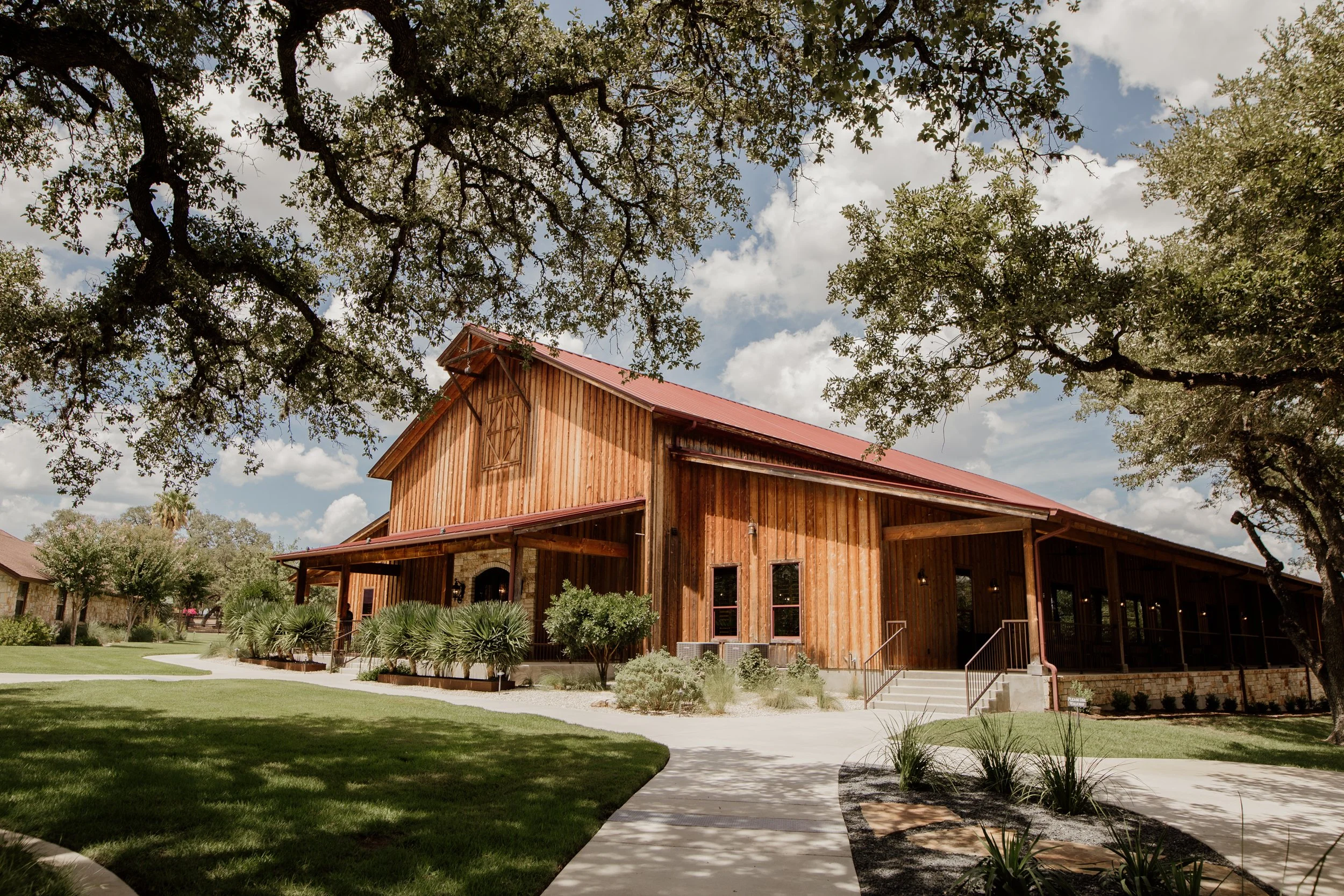 The exterior of Chandelier of Gruene in the later afternoon showing blue skies and green treens