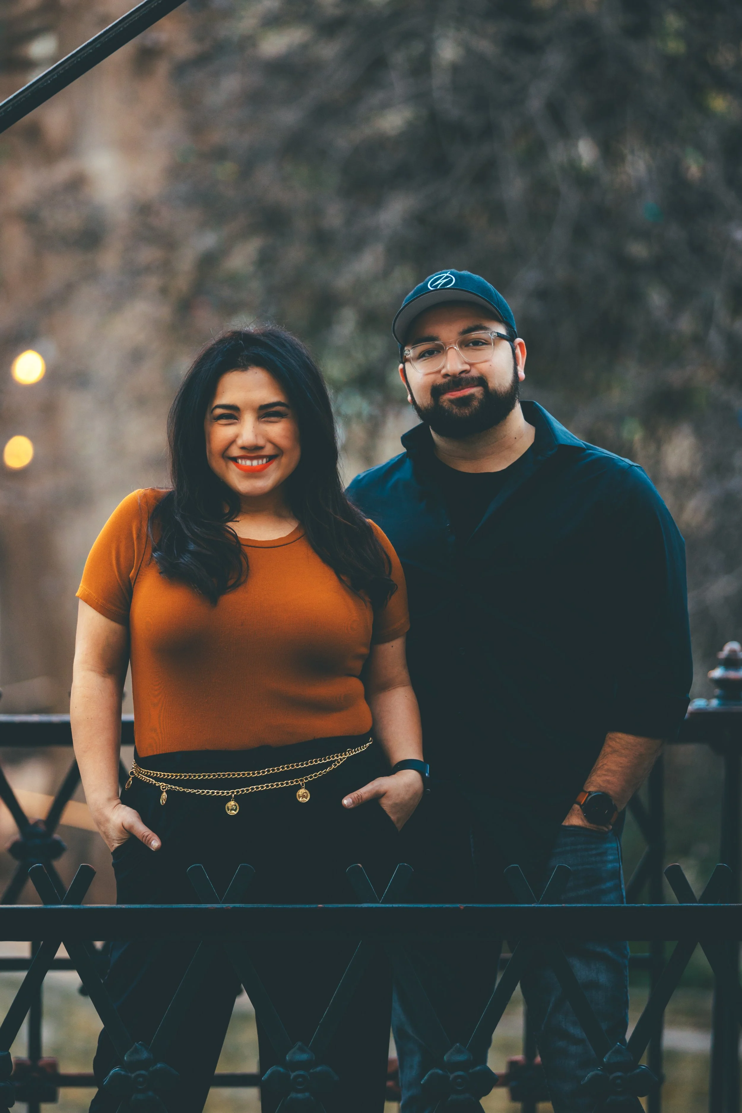 Two people standing on a bridge smiling outdoors posing for a OneAway Studios Photo Shoot (photoshoot)