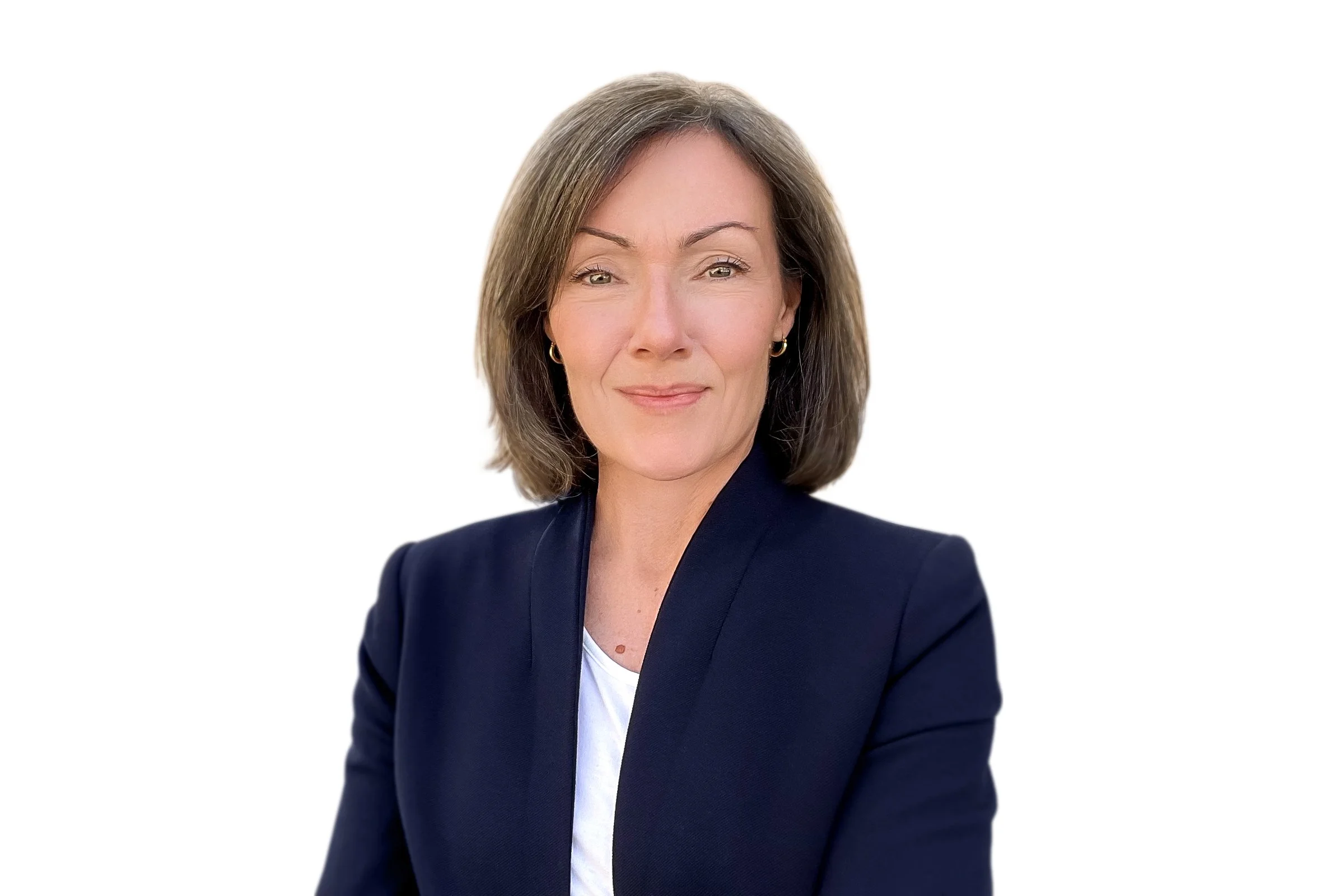 Portrait of a woman with short, brown hair, wearing a navy blazer and white shirt, against a white background.