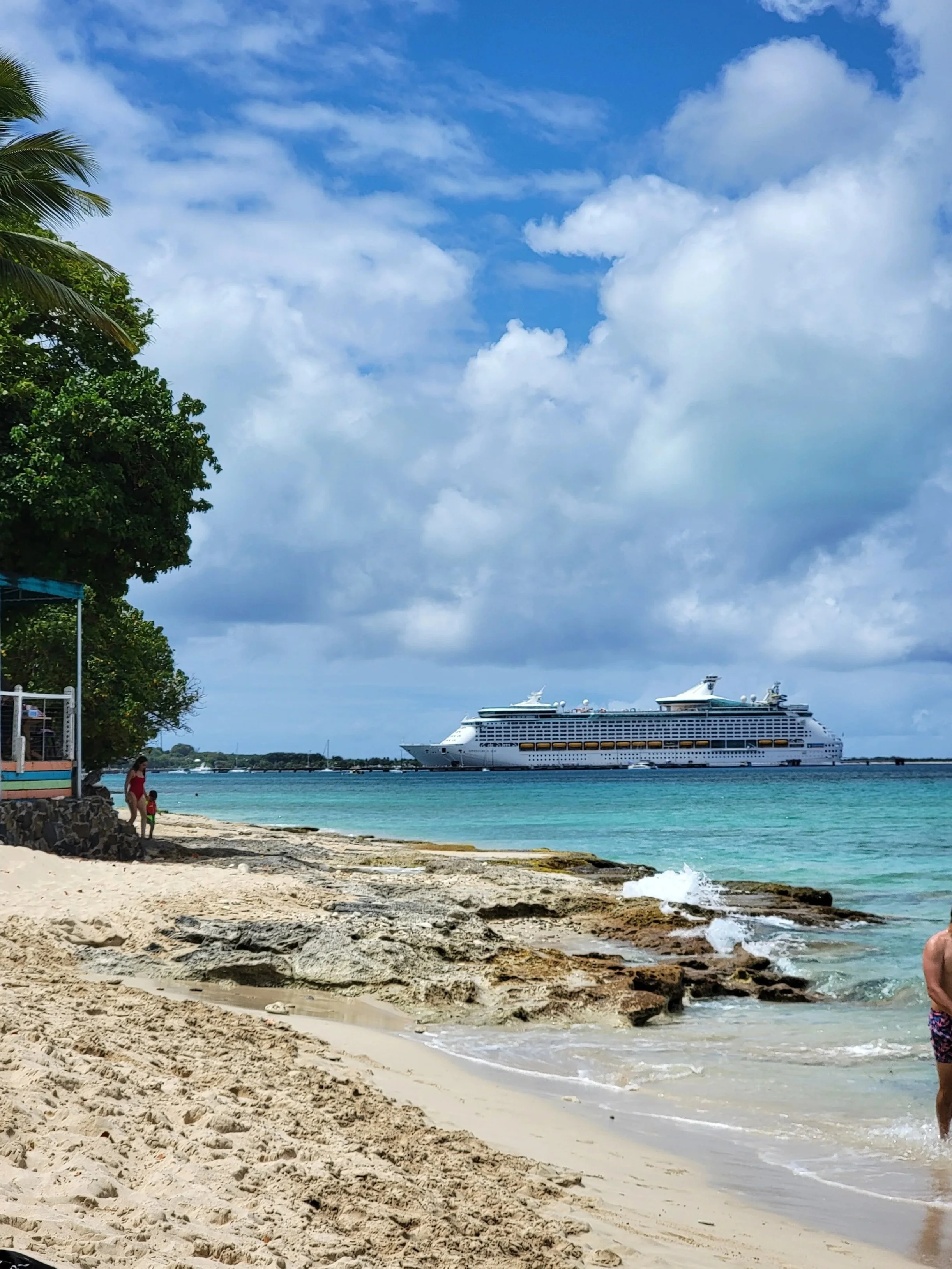 Cruise ship in the distance docked at a Caribbean port