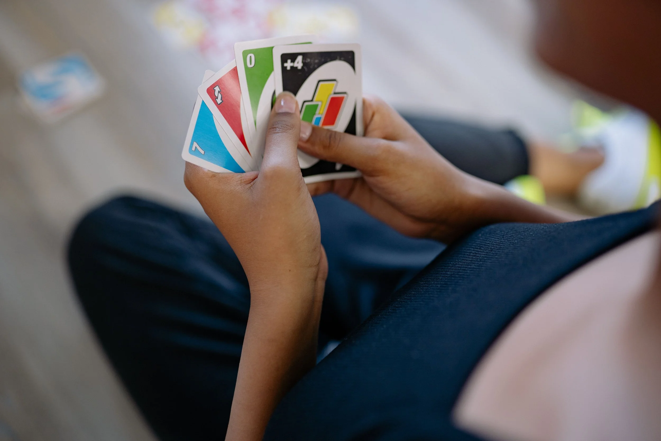 person playing uno card game