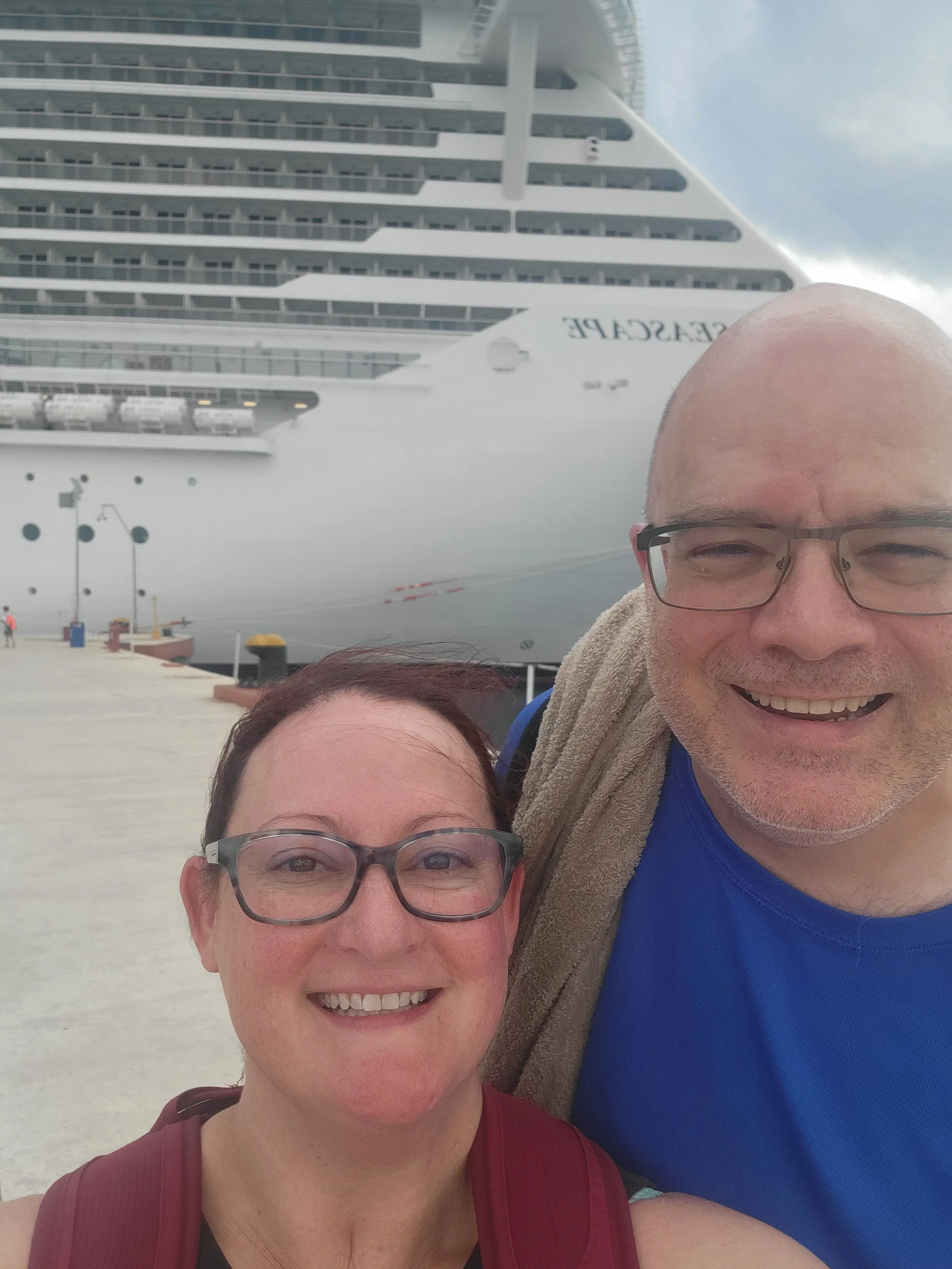 couple taking selfie on pier in front of MSC Seascape