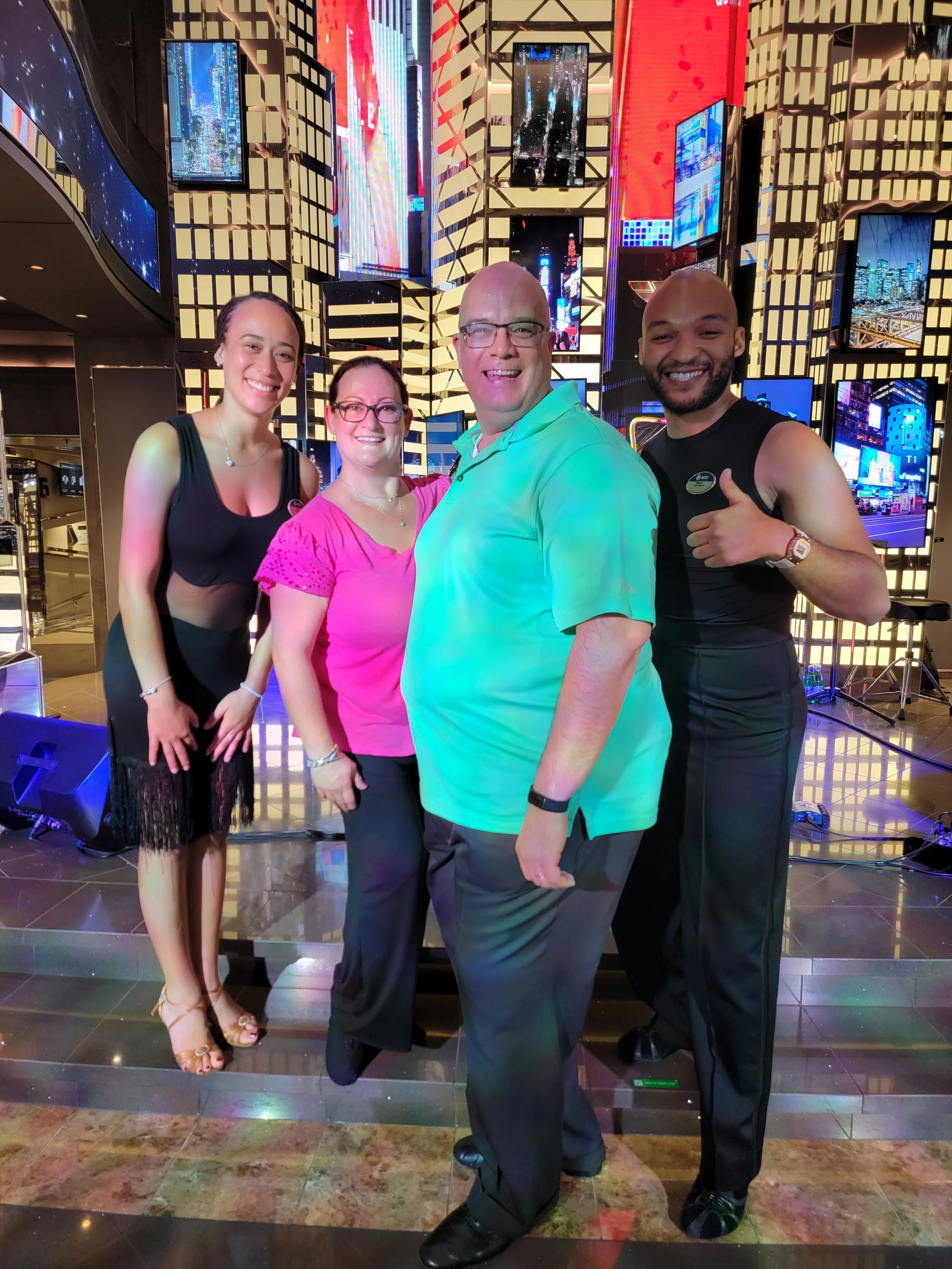 Couple with dance instructors after a class on cruise ship