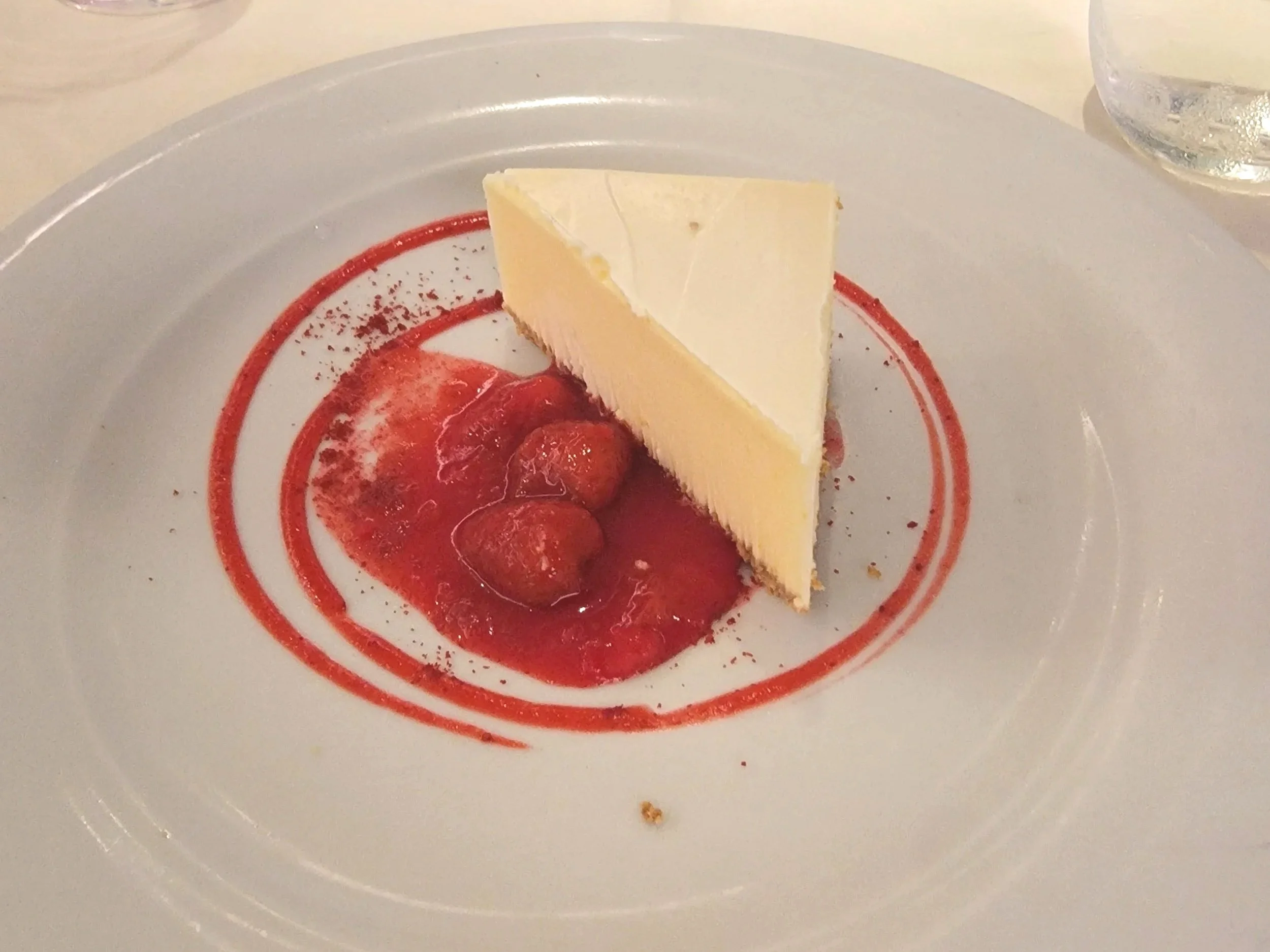 Slice of cheesecake with strawberry sauce