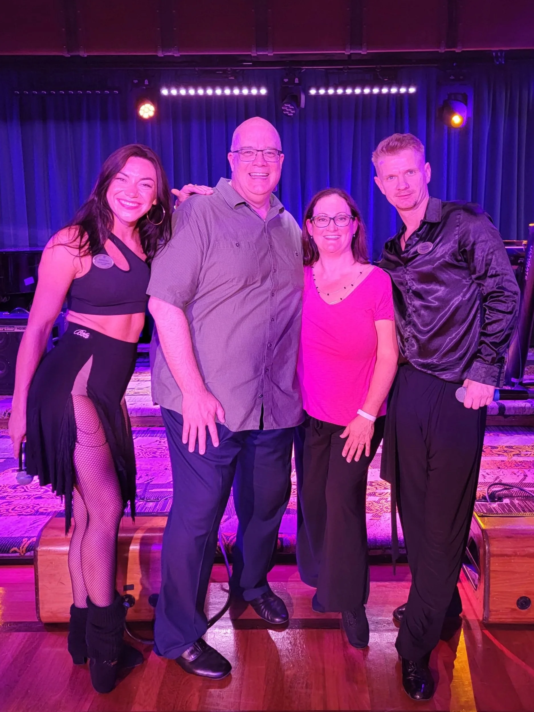 Couple with dance instrucors after a lesson on a cruise ship