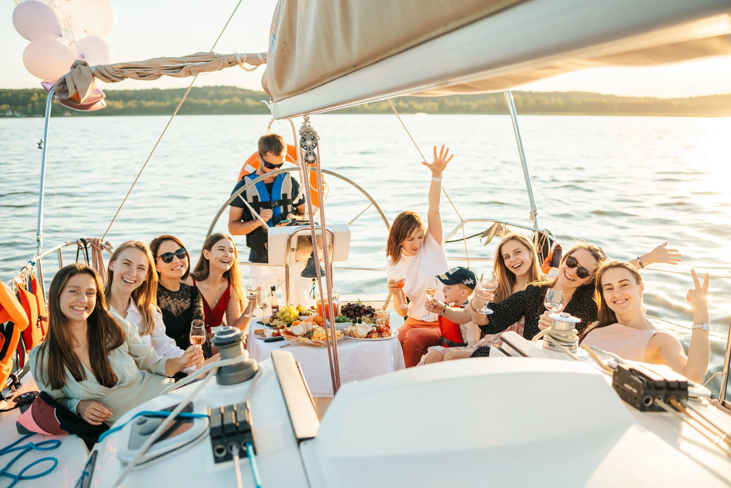 women on a white boat with drinks