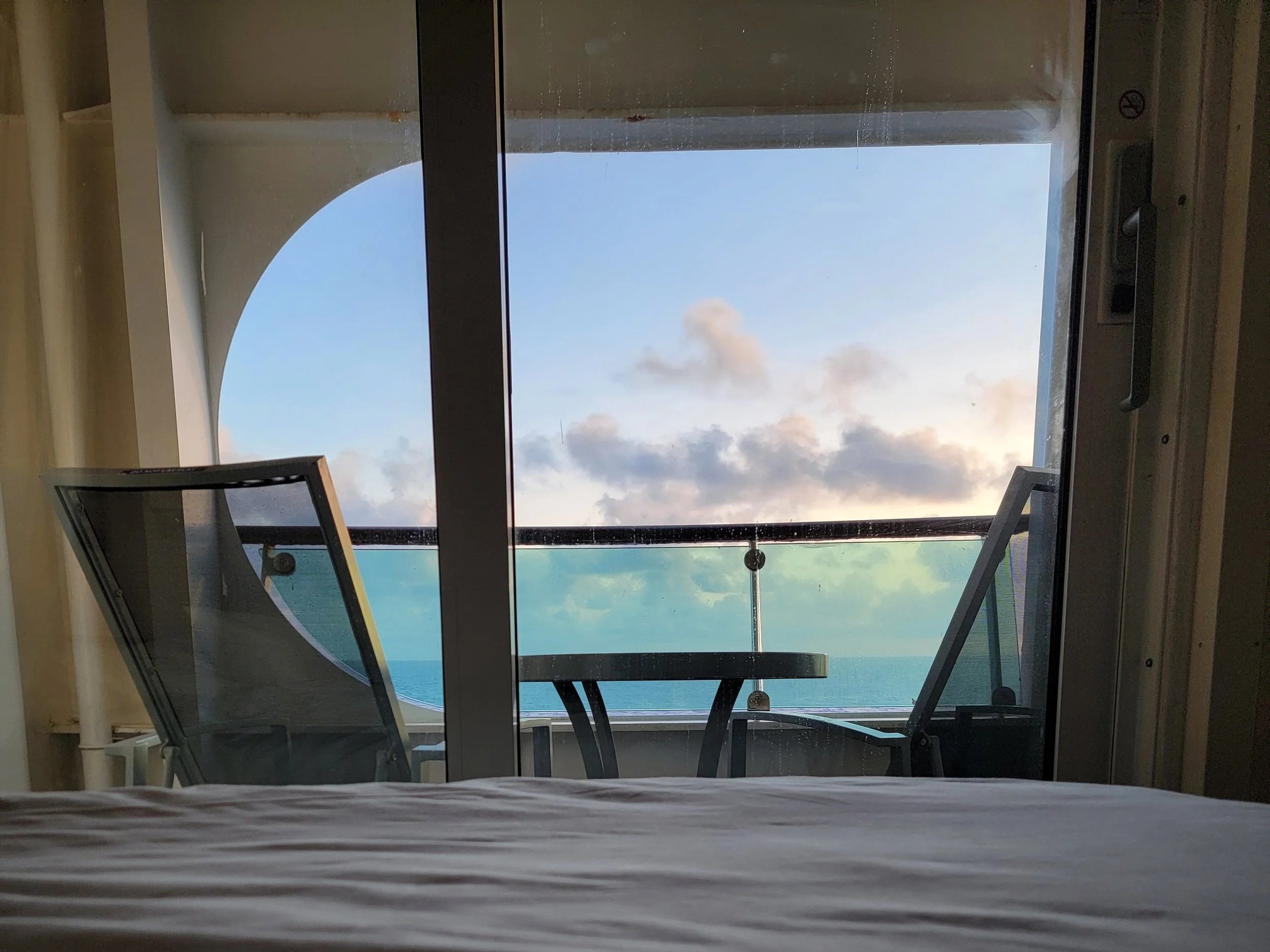 View of balcony from inside a cruise ship cabin