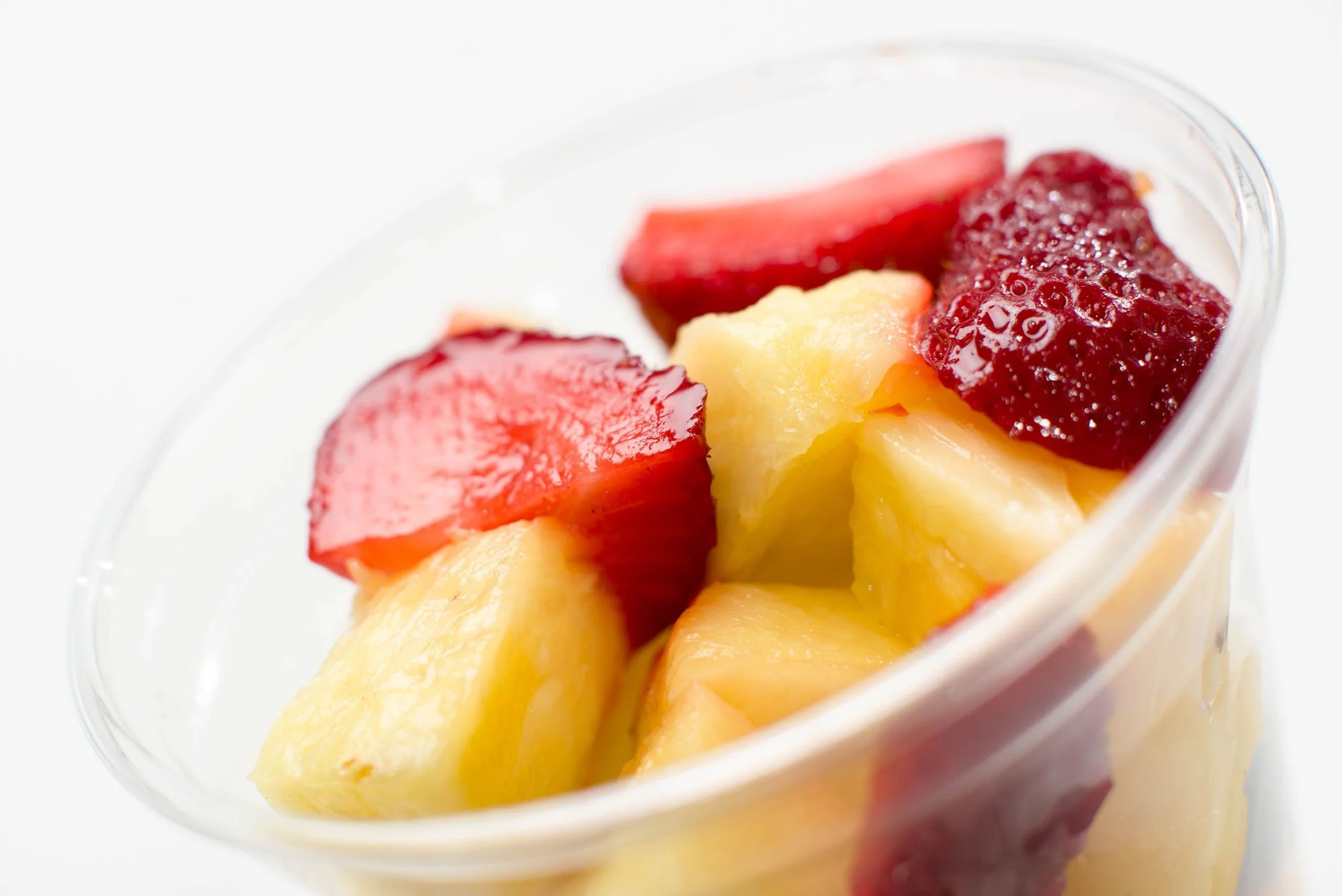 fruit cup with cut strawberries and pineapple