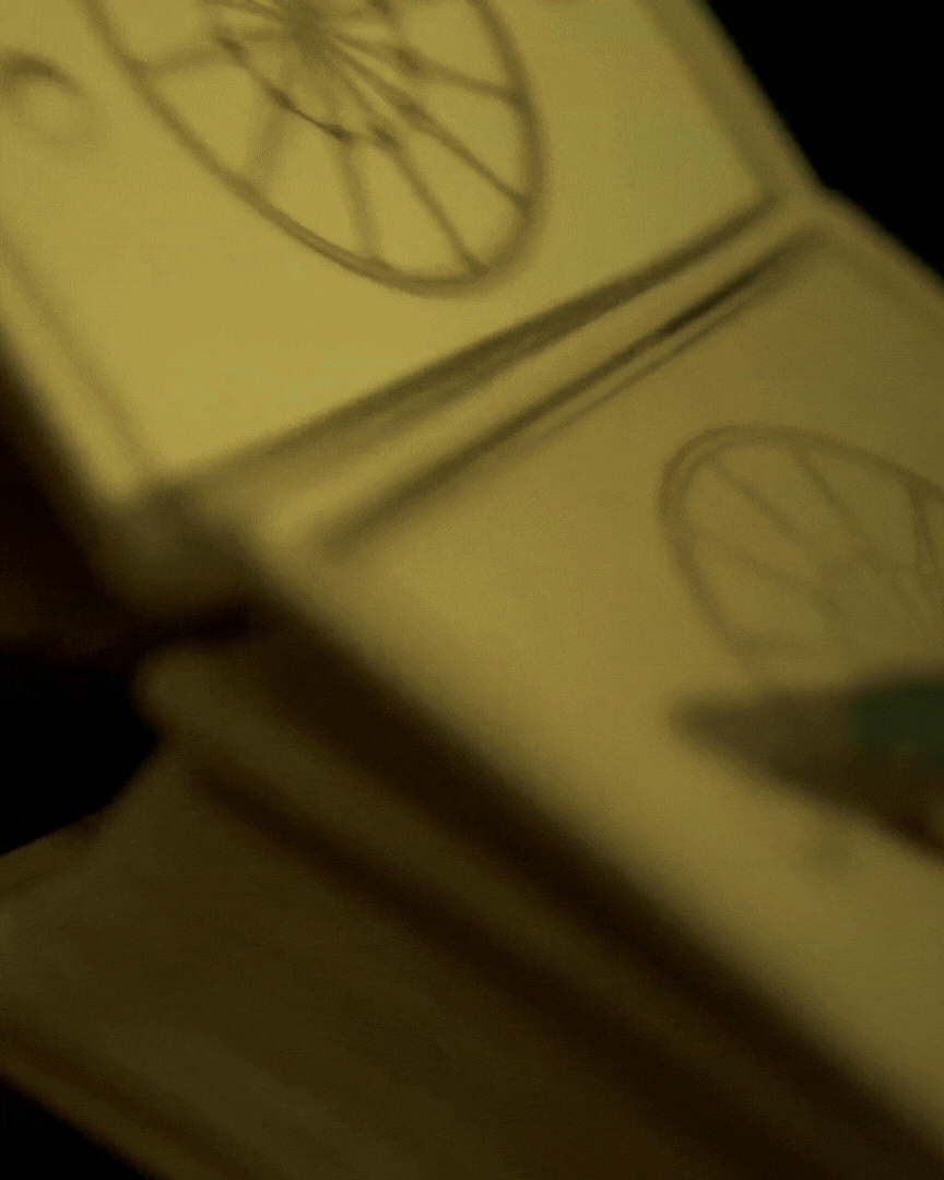 Close-up of a yellow pack of chewing gum with a circular logo on the front.