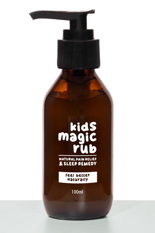 A brown bottle with a black pump dispenser labeled "kids magic rub," claiming to provide natural pain relief and sleep remedy for children, containing 100ml.