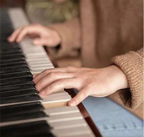 Close-up of a person's hands playing the piano.