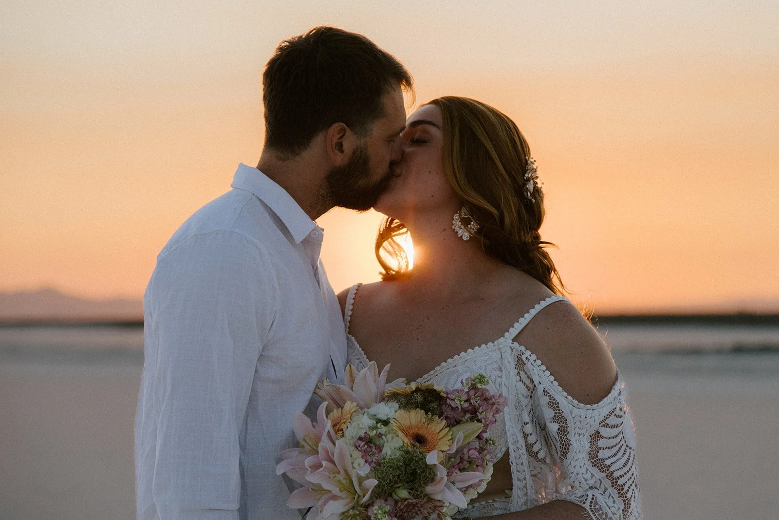 molly and joe salt flats sunset kiss.jpg