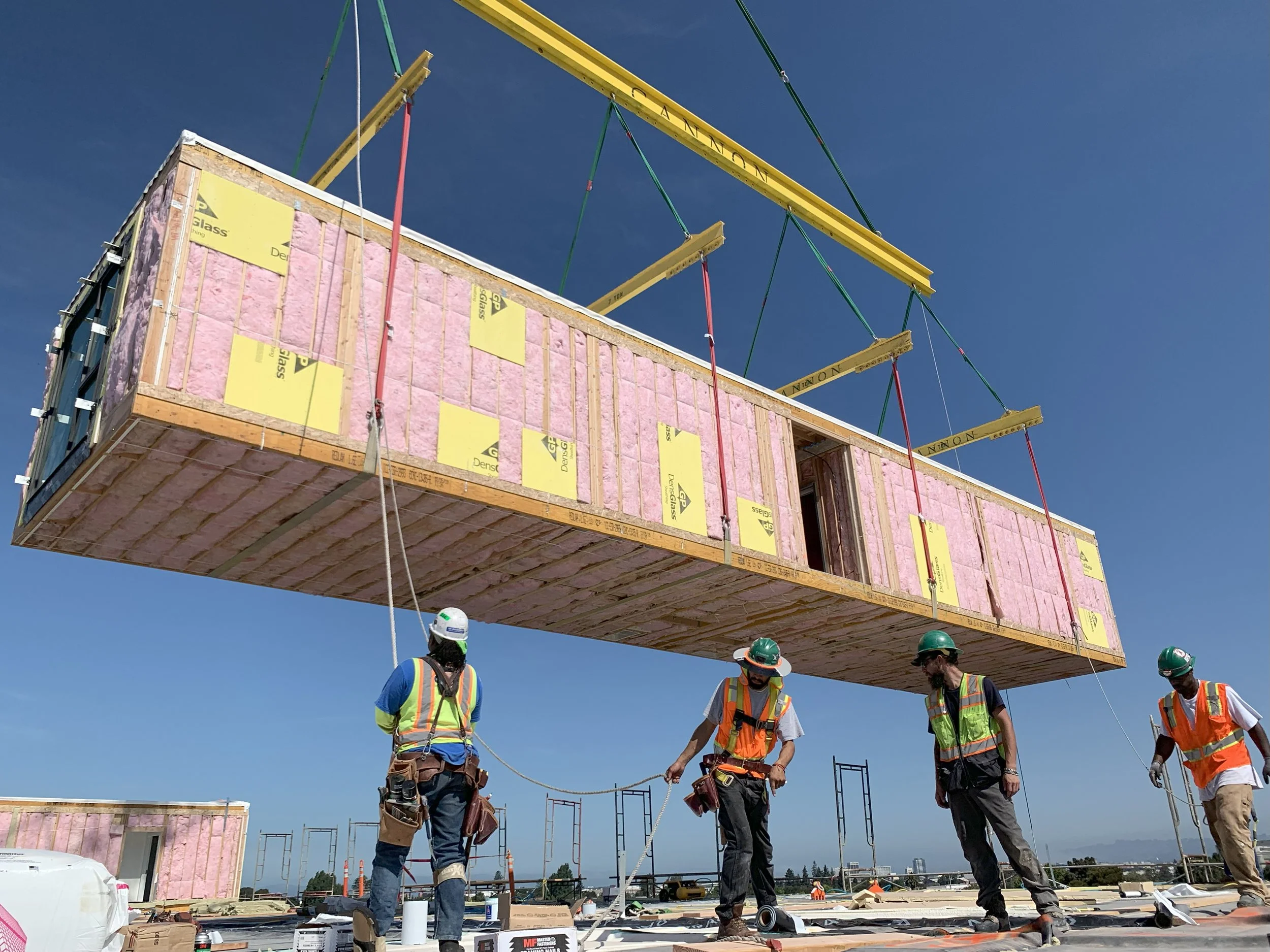 Setting a prefabricated modular residence during construction.