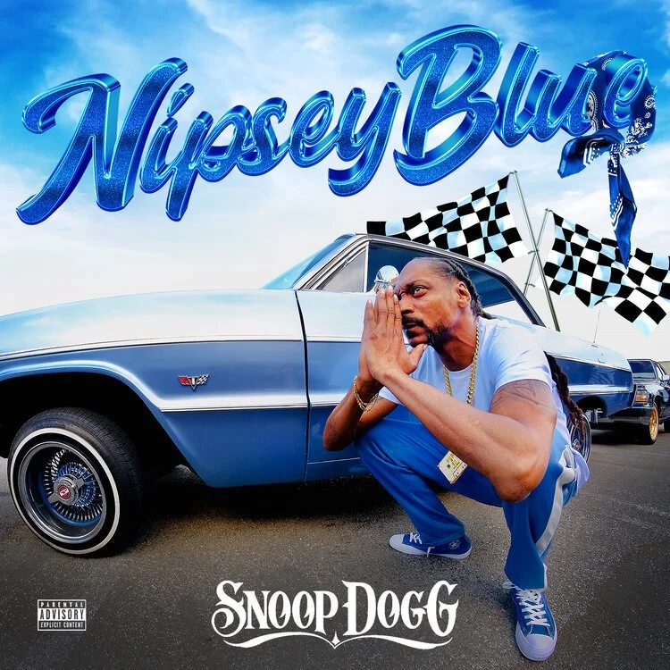 A man kneeling next to a blue vintage car with "Nipsey Blue" text above. Checkered flags are in the background. The words "Snoop Dogg" are at the bottom, styled as a logo.