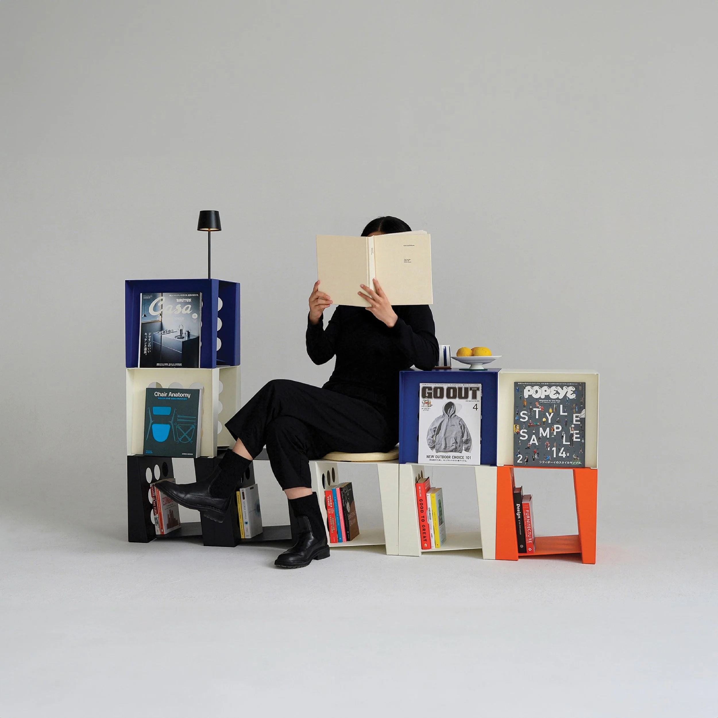 Multiple Tilted Book Seats in black, white, blue, and orange, stacked and composed to create a personalized arrangement.