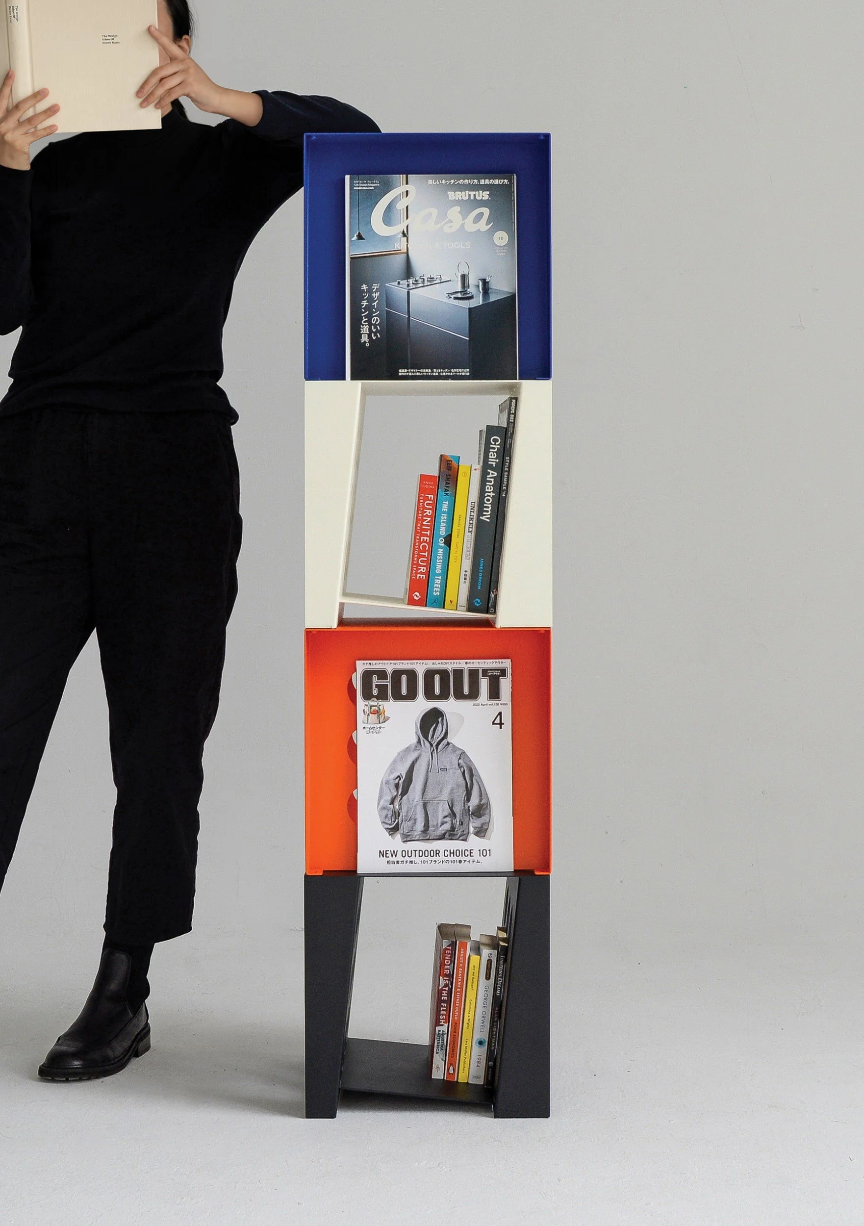 Stacked Tilted Book Seats forming a vertical bookshelf, holding books upright and displaying covers like a mini gallery.