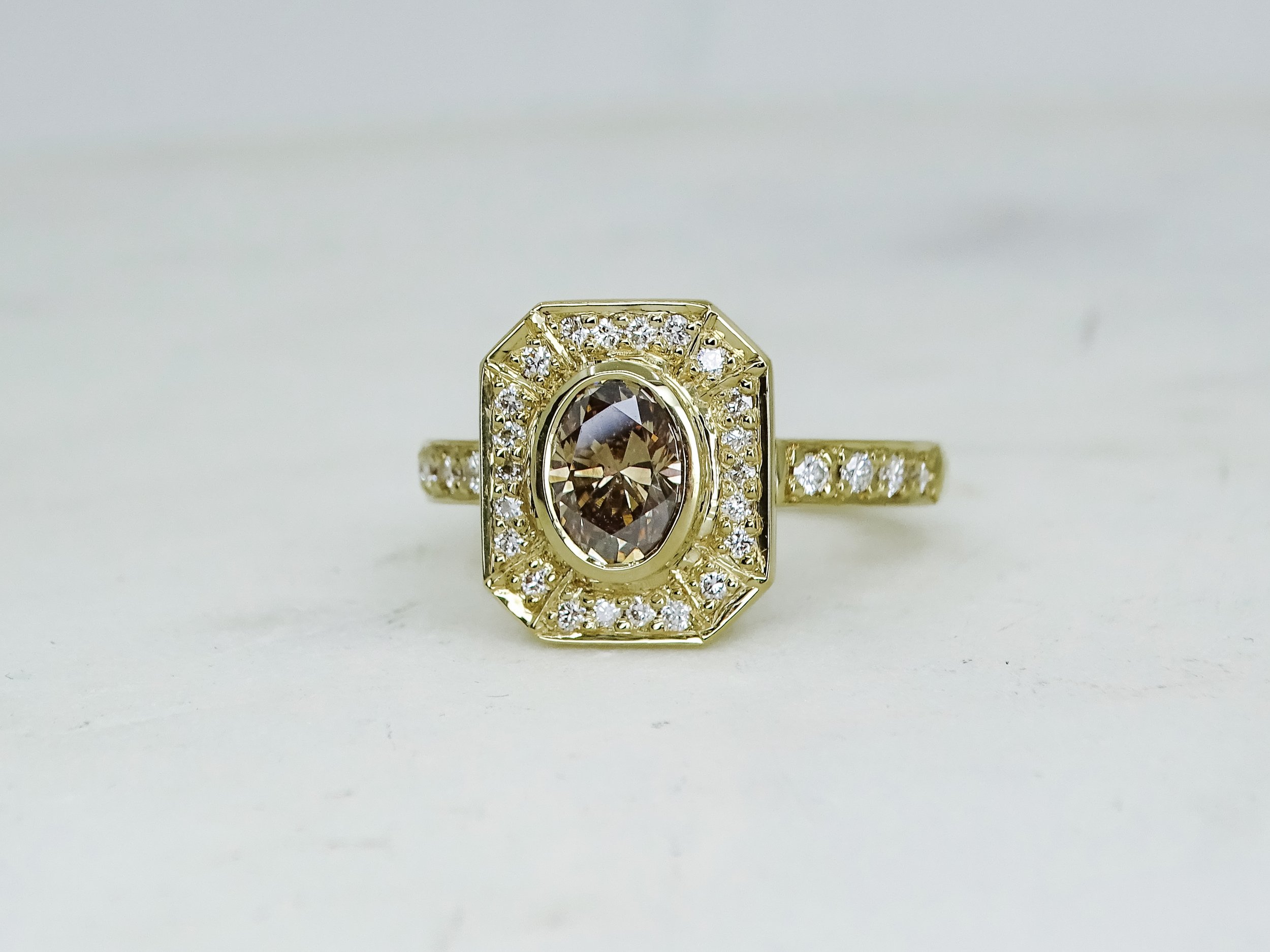 18ct yellow gold Argyle champagne diamond with diamond halo ring. 