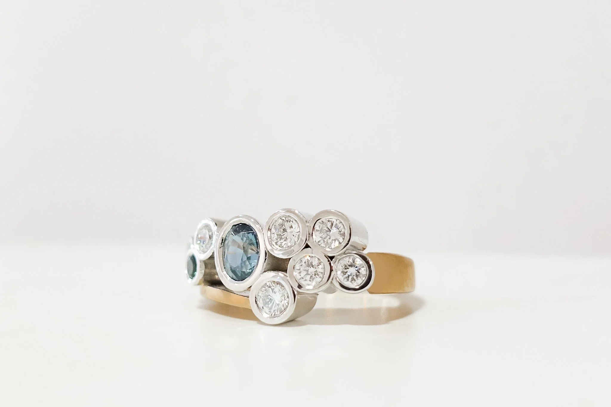 18ct rose and white gold dress ring with teal sapphires and diamonds. 