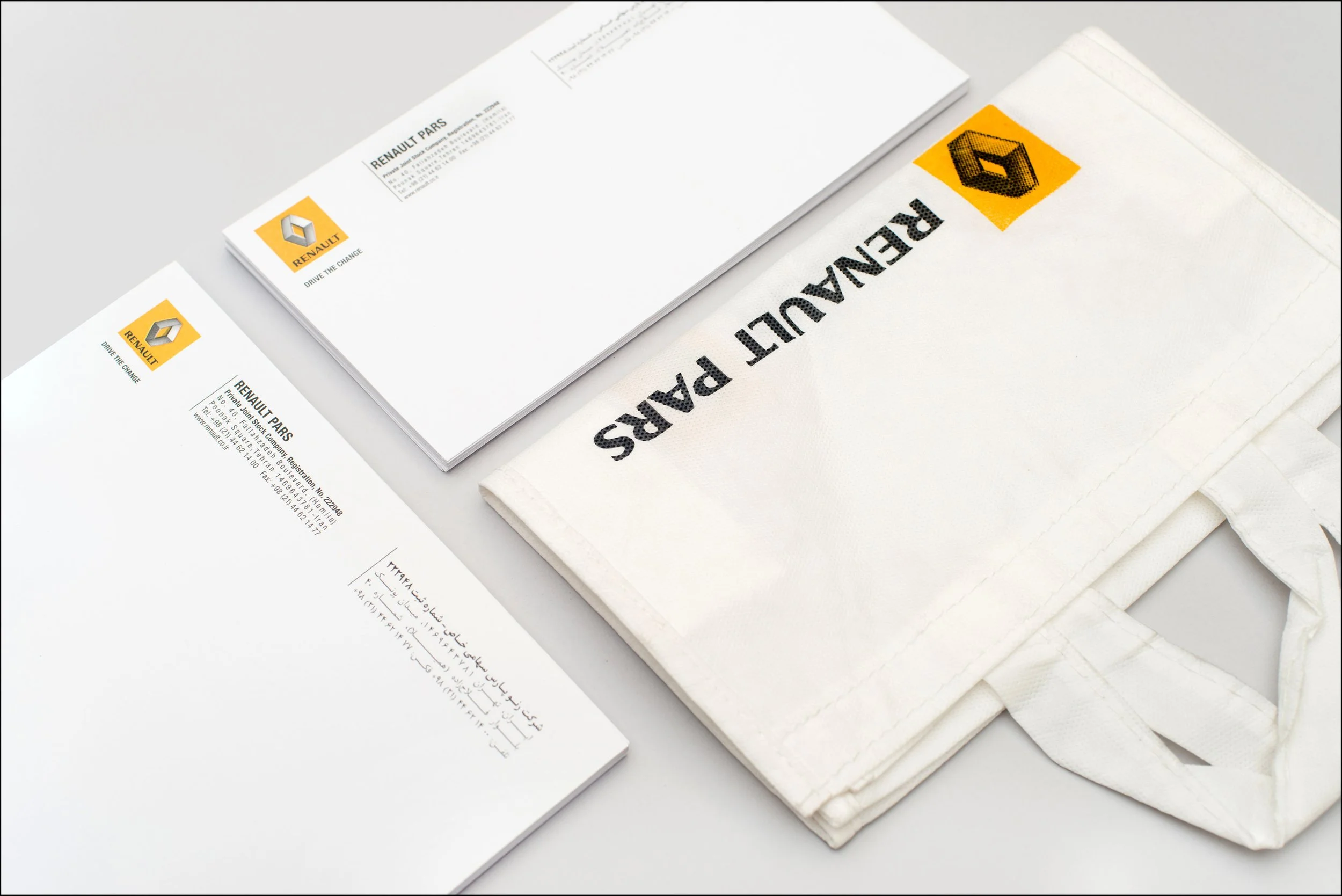 A collection of Renault Paris branded stationery items, including envelopes, letterhead, and a tote bag with the Renault logo.