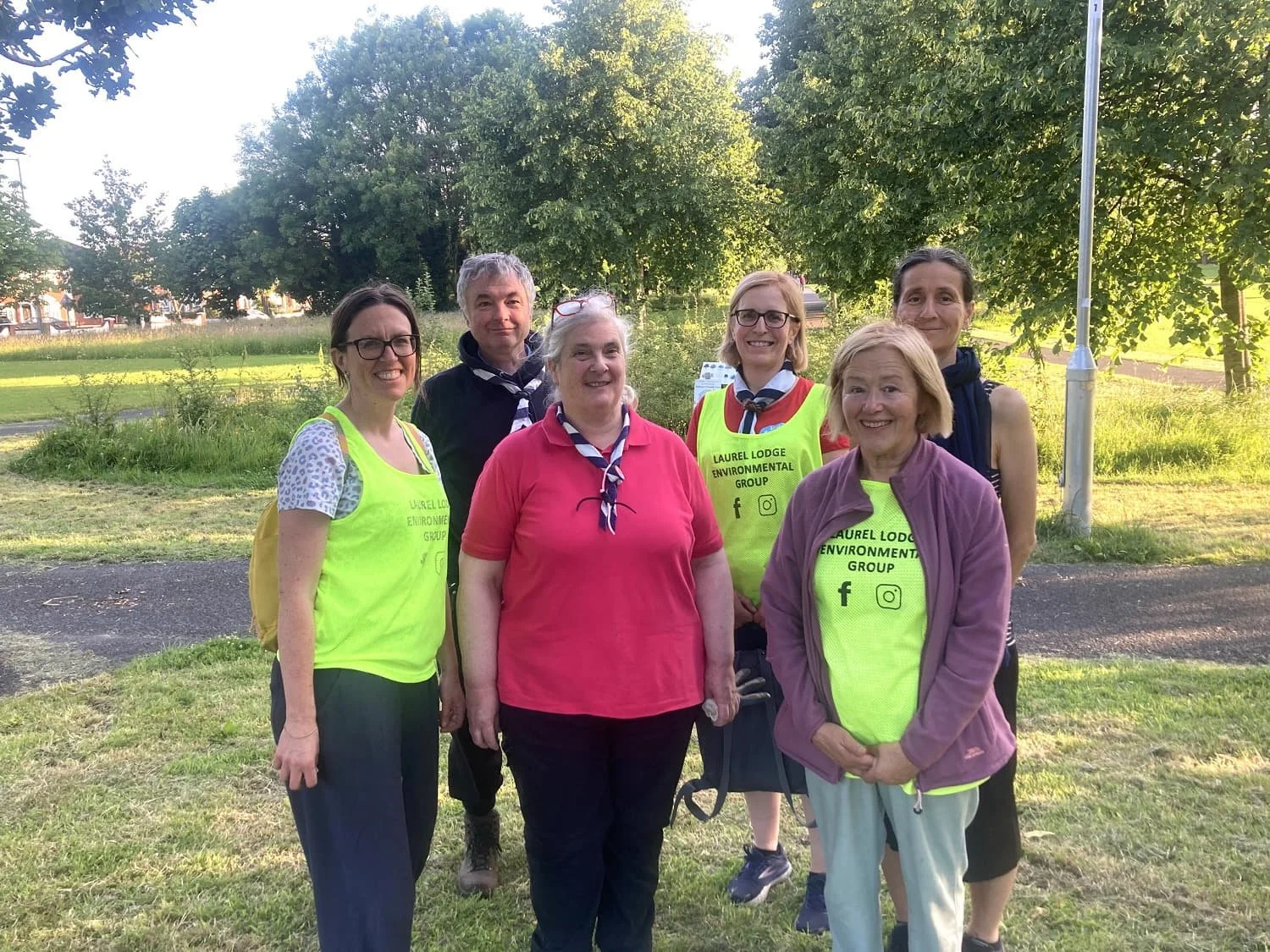Laurel Lodge Environmental Group partners - A group of Castleknock Scouts standing outdoors on grass on a sunny day, wearing bright yellow T-shirts