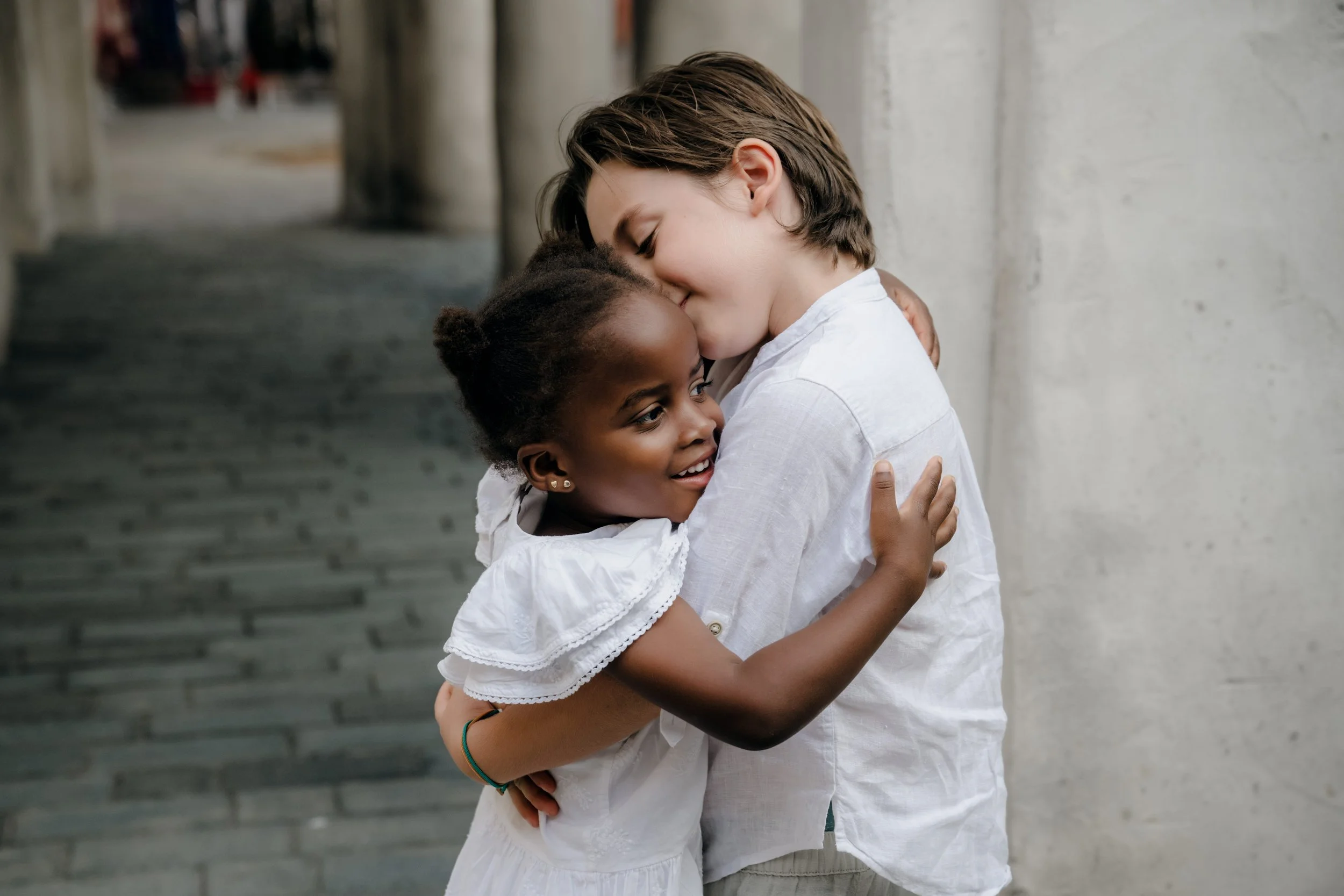 Brother and sister sharing a sweet hug in Old Dubai.