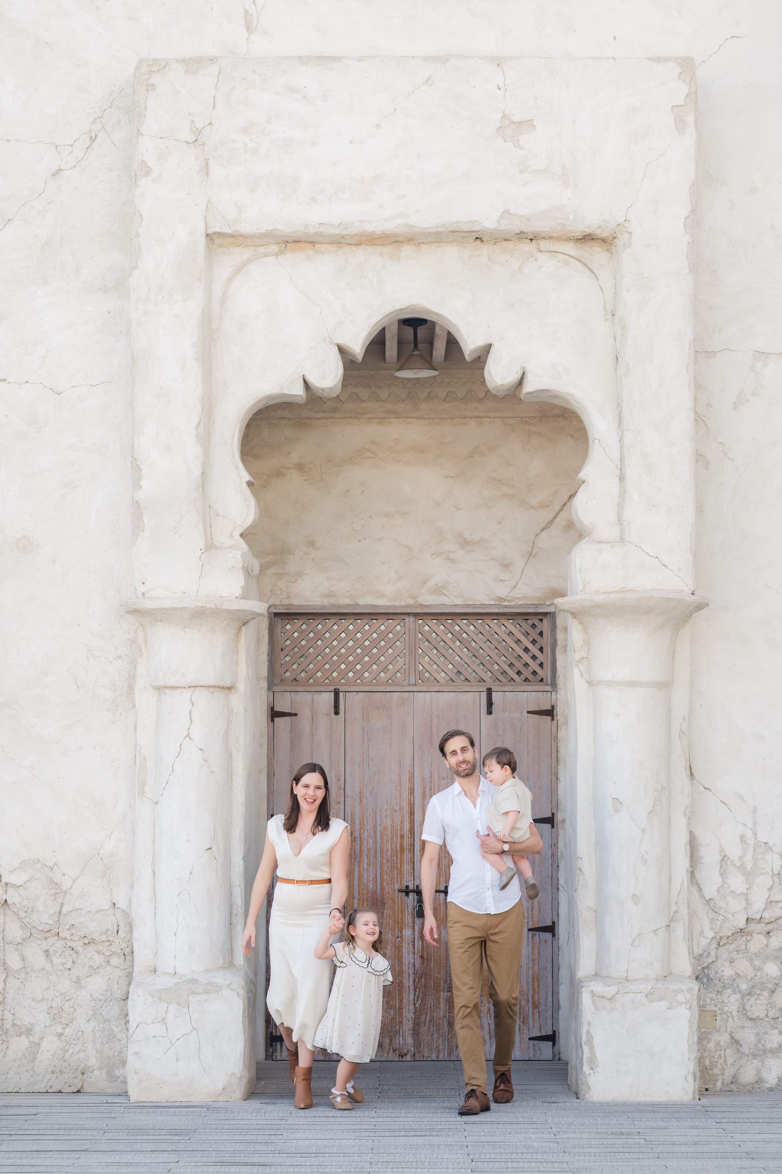 Family walking together in Al Seef district during a Dubai family photo session